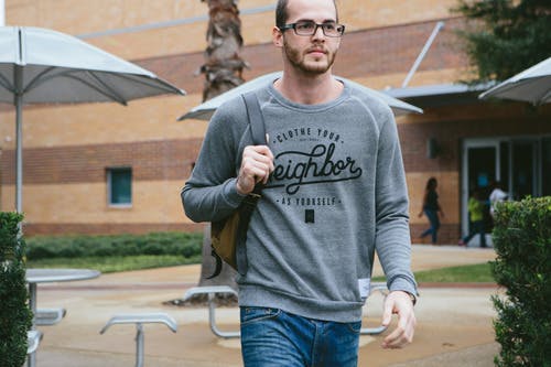 man wearing a grey sweatshirt with black print