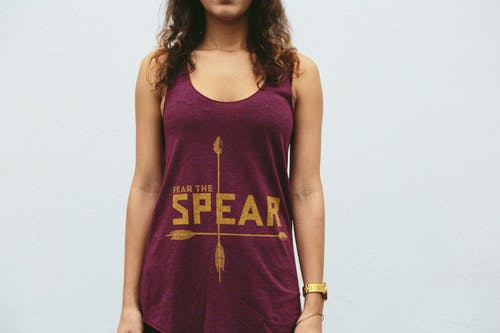 women wearing a maroon tank top with gold print