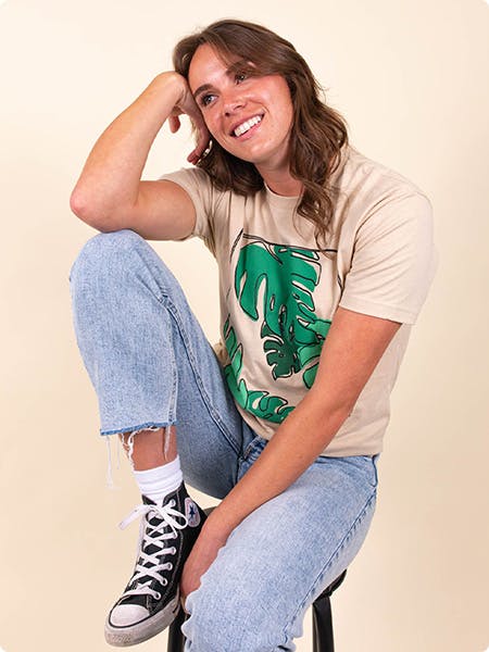 women wearing a tan tee with plant leaves printed on it women wearing a tan tee with plant leaves printed on it