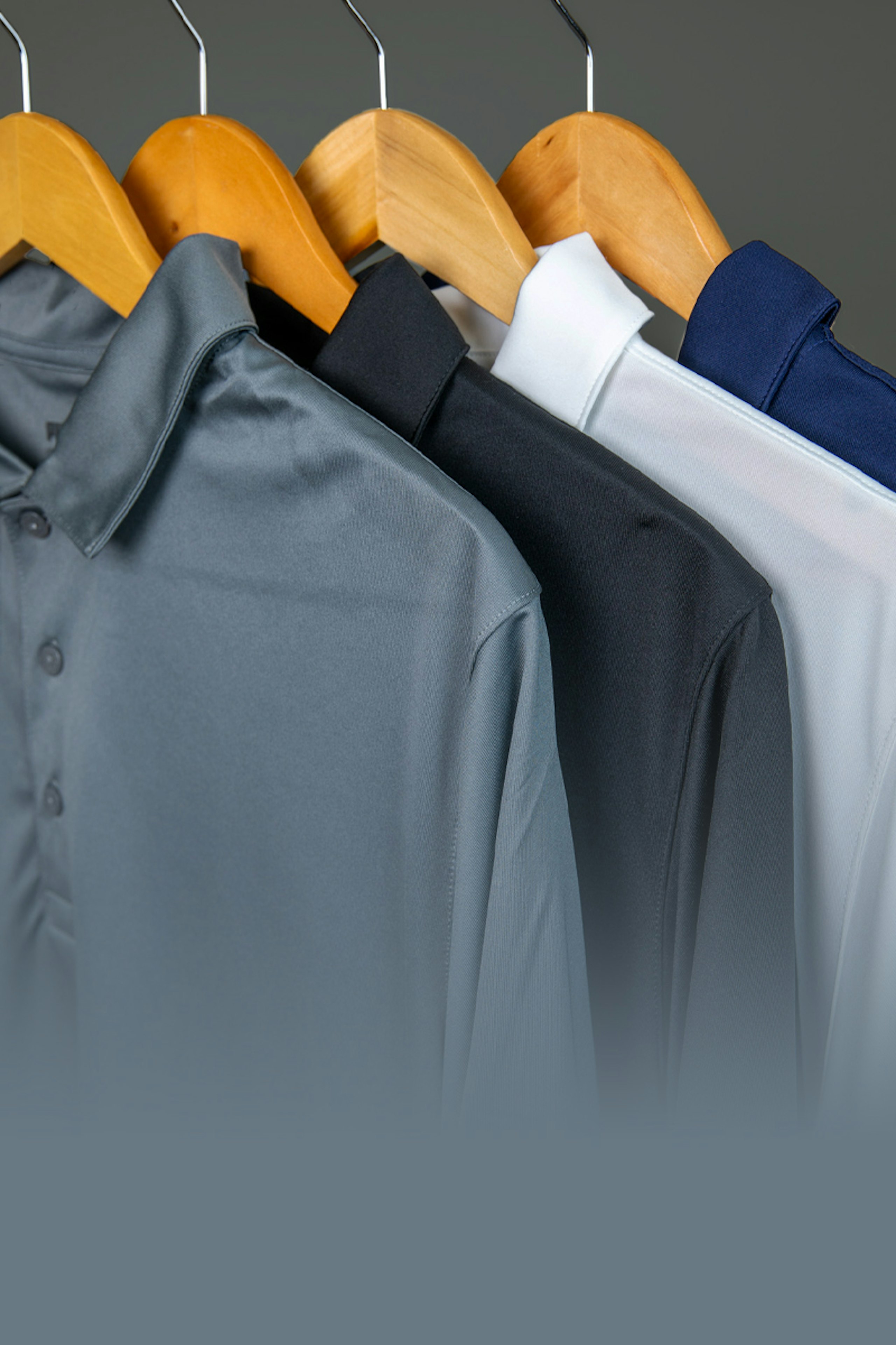 collection of polos hanging on hangers