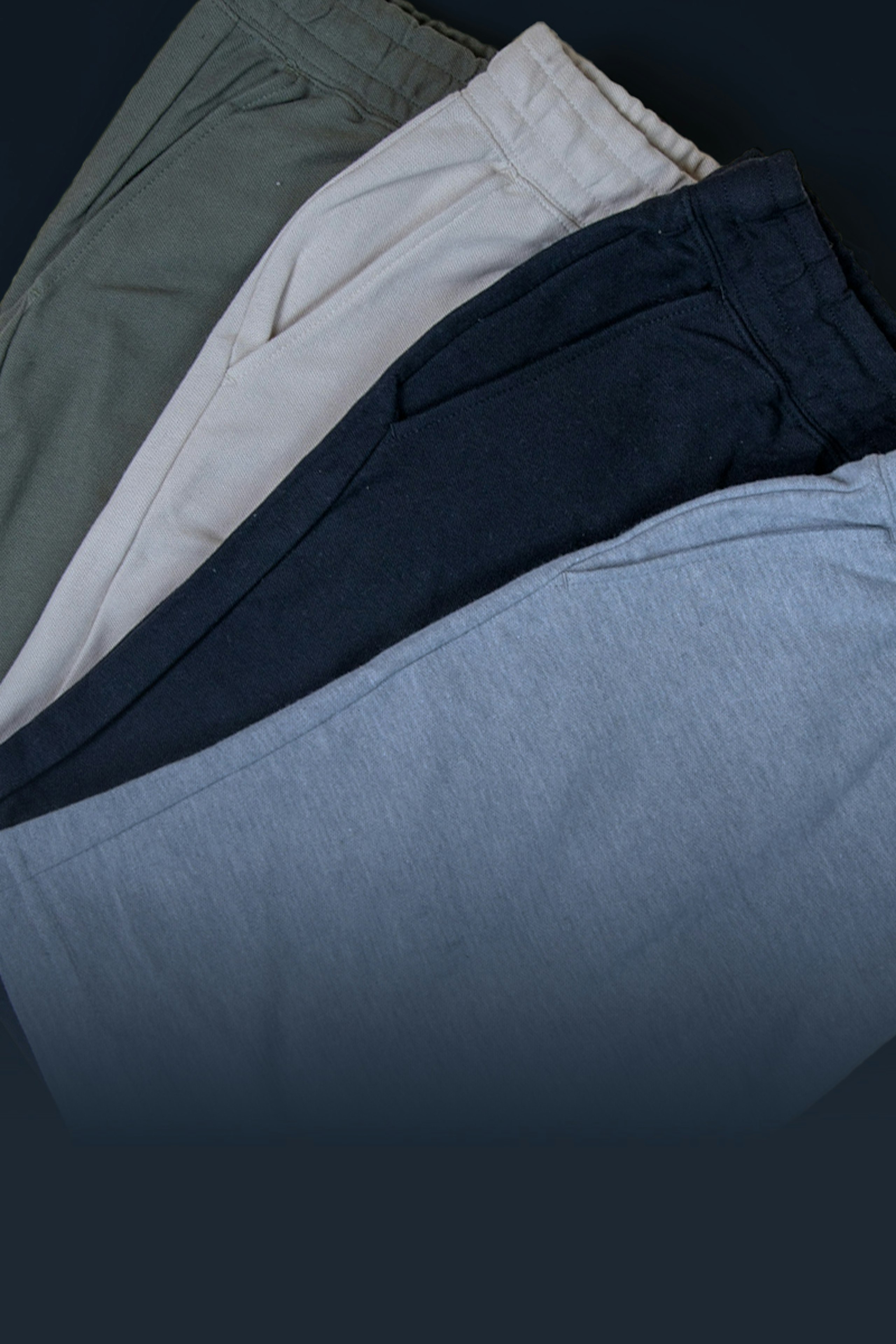 four shorts folded laying flat fanned on top of each other