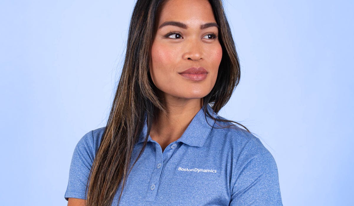 women wearing a blue polo with embroidered logo