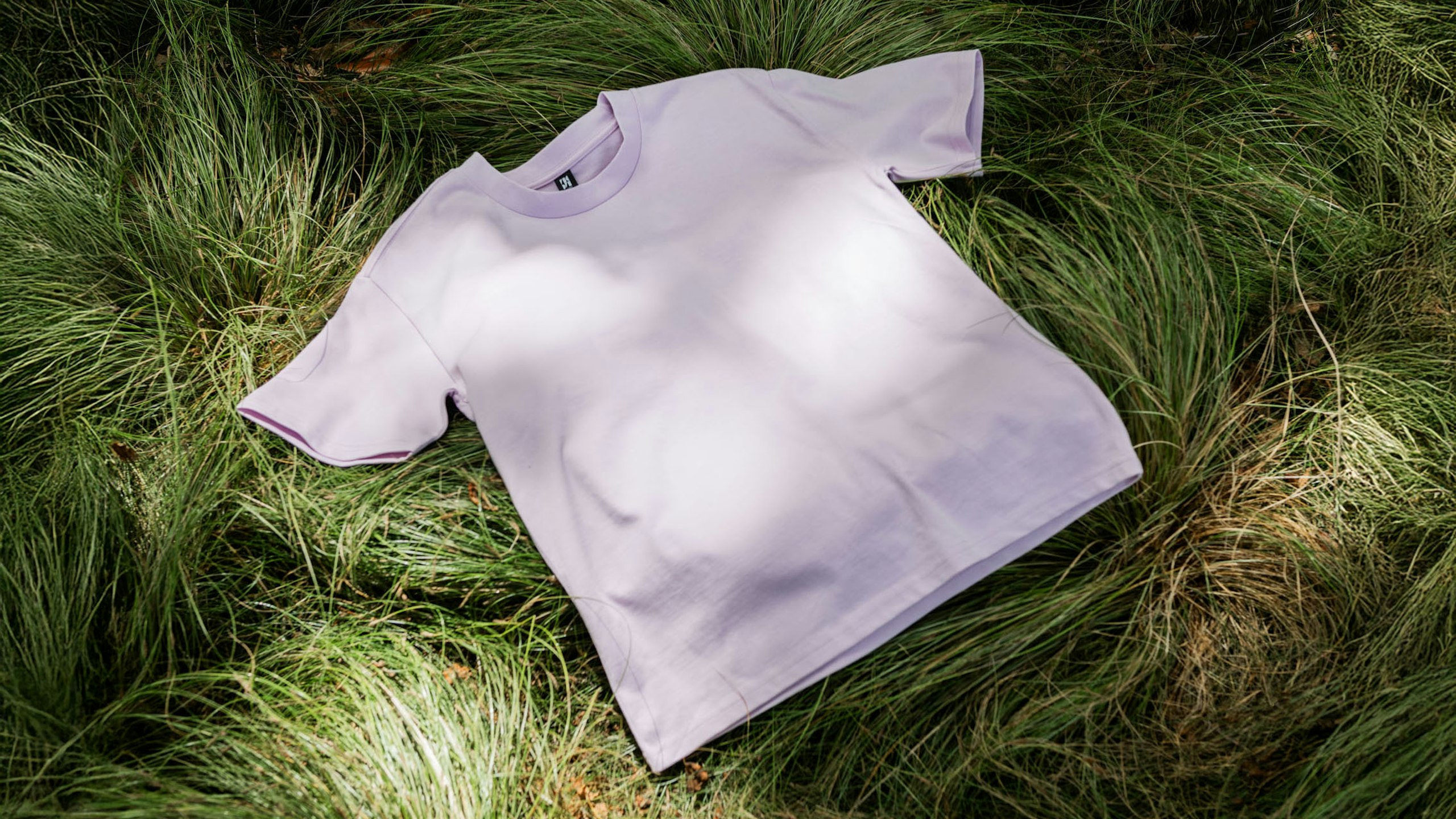 orchid color tee on grass