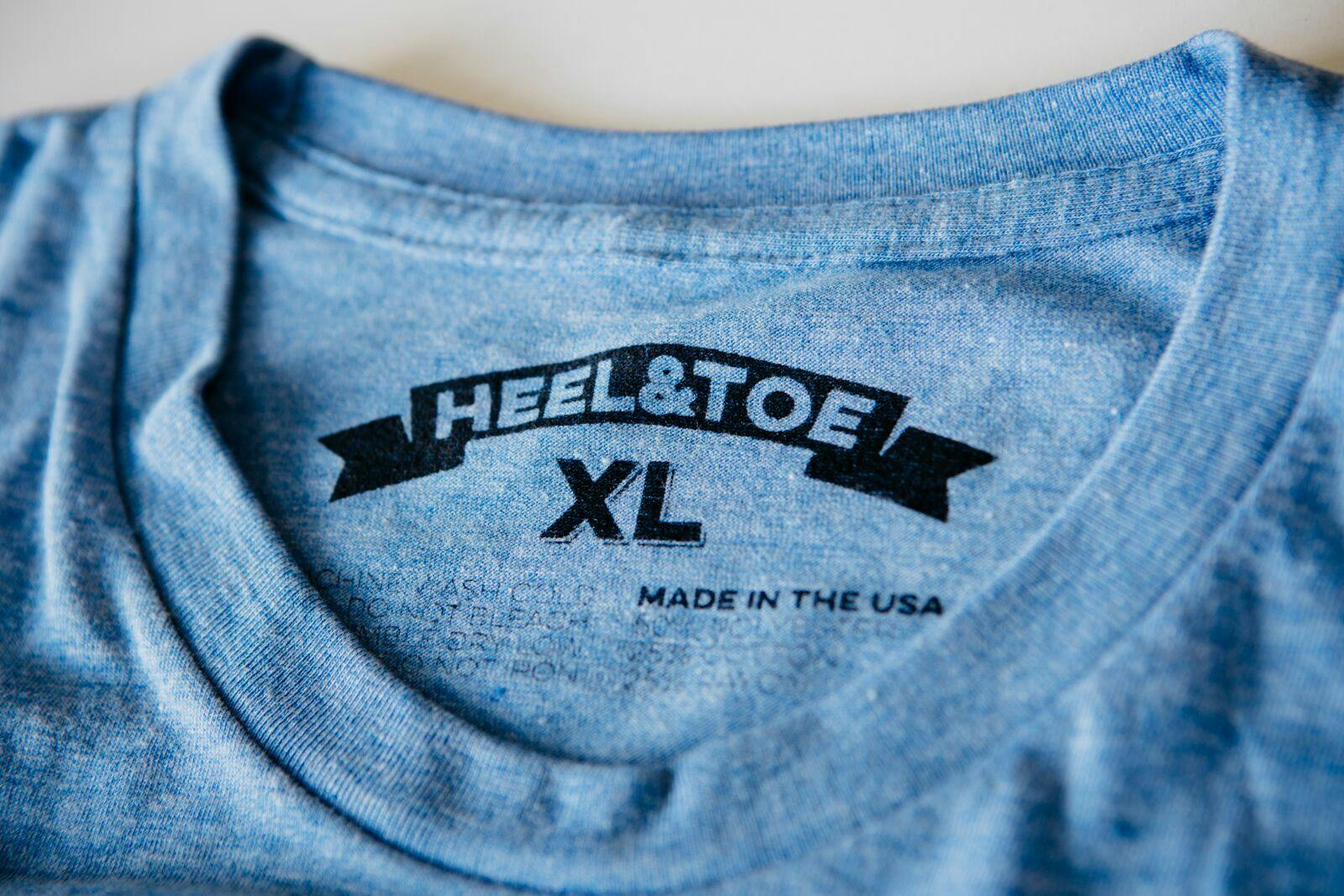 heather blue shirt with a black printed tag heather blue shirt with a black printed tag