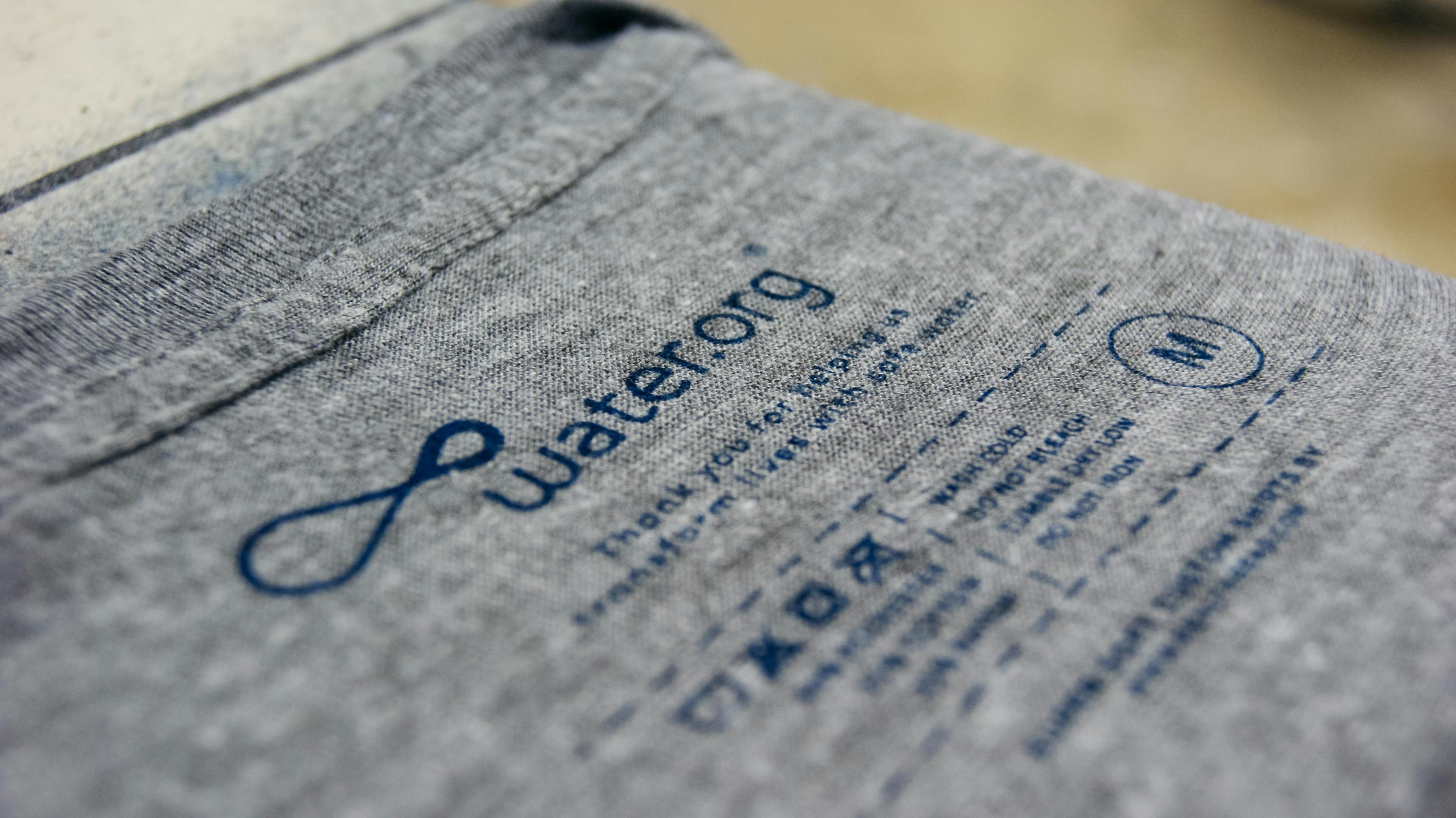 side view of a printed tag on a dark gray heather shirt side view of a printed tag on a dark gray heather shirt