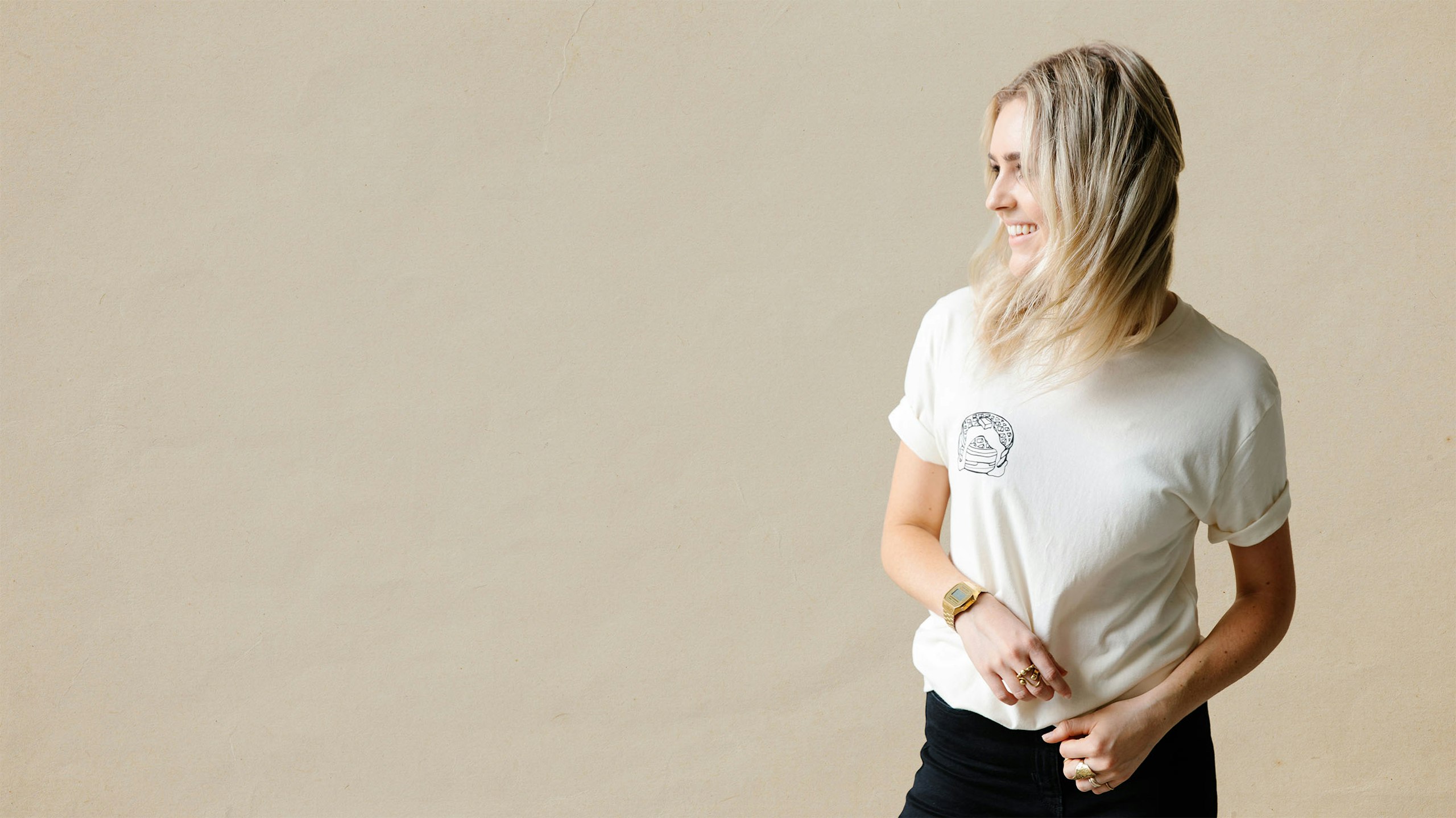 women wearing a bone color t-shirt with pancakes printing on the left pocket
