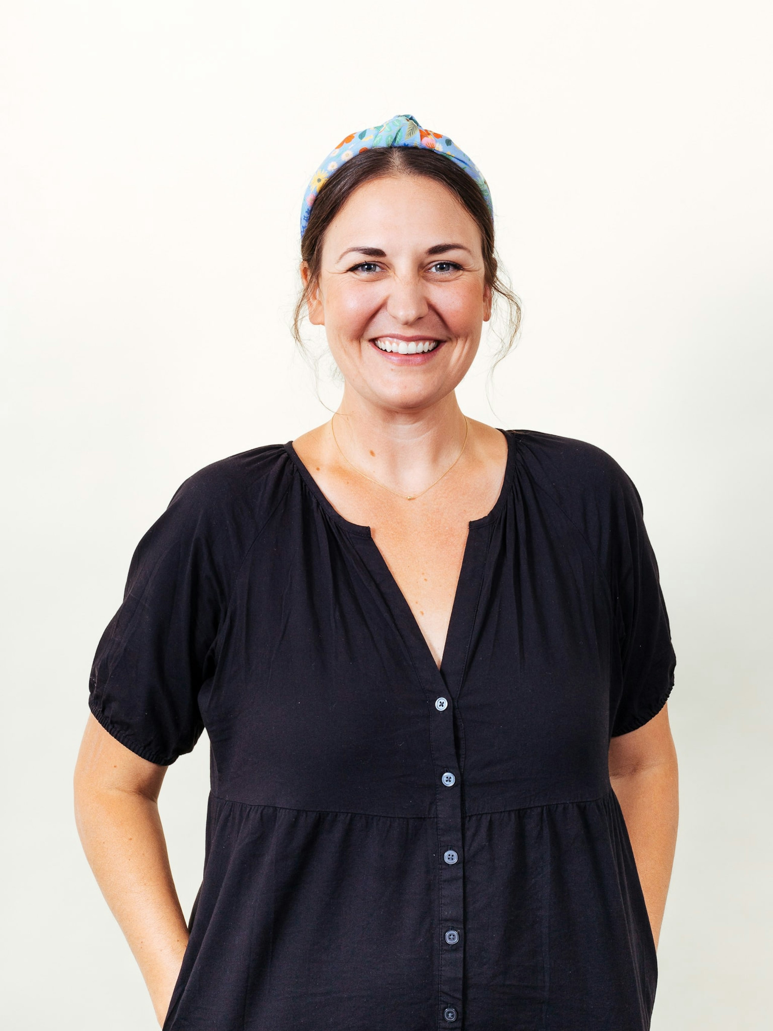 a women posing in front of a white background