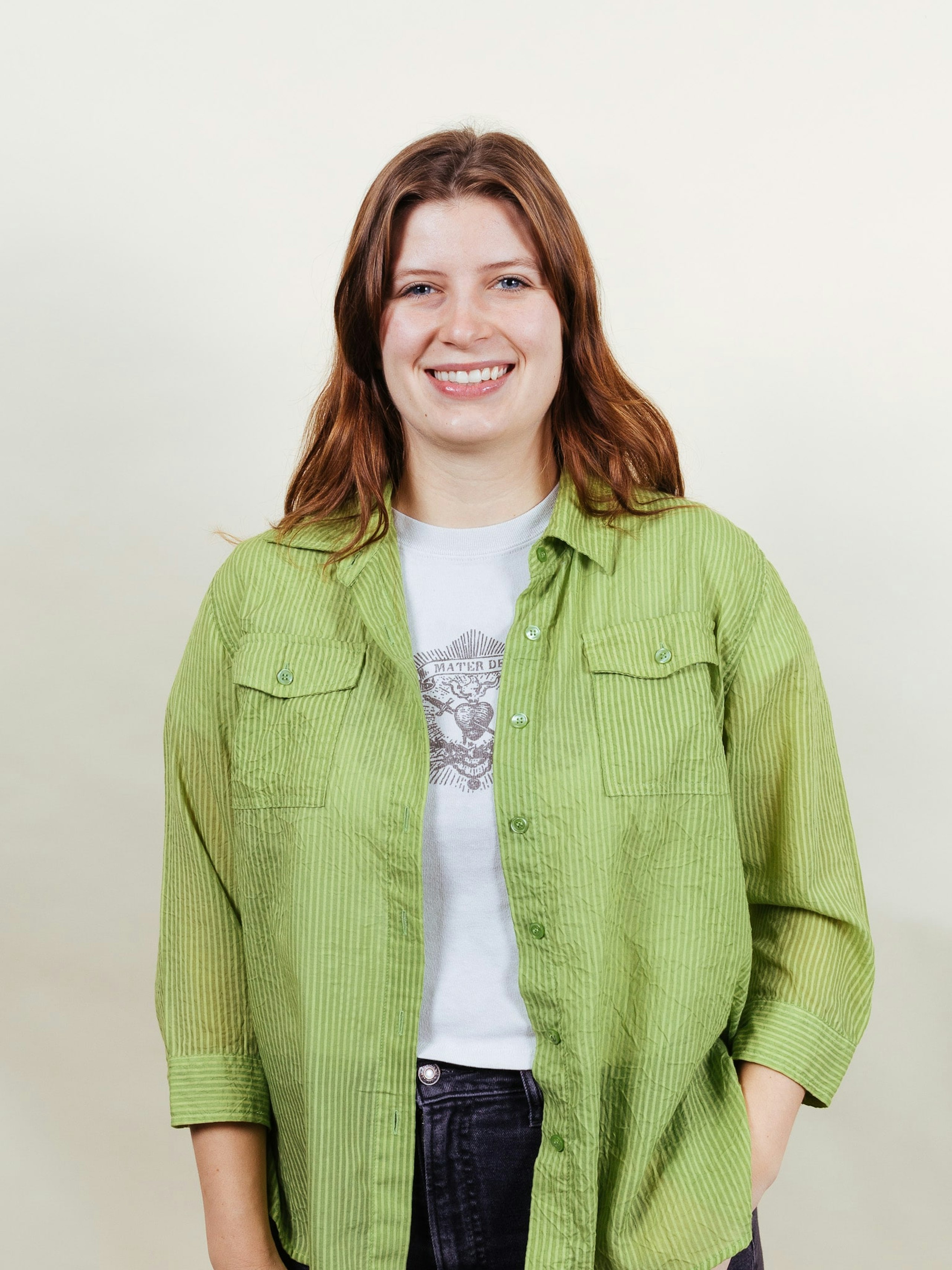 a women posing in front of a white background
