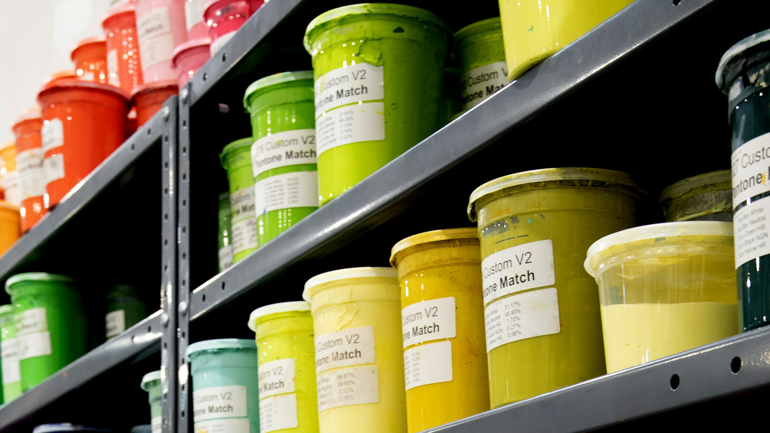 yellow, green, and orange inks on a shelf