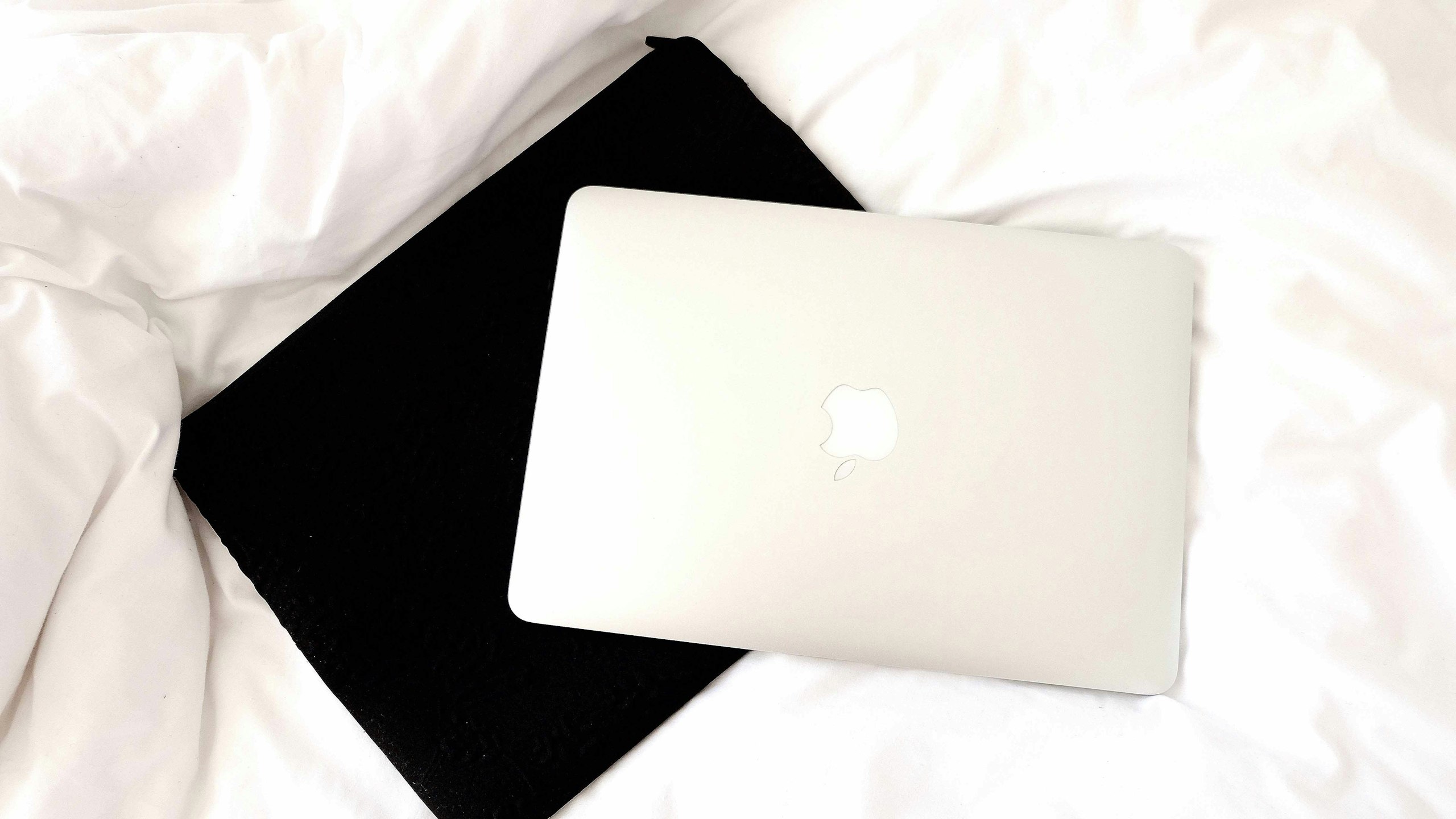 laptop sitting on top of a laptop sleeve