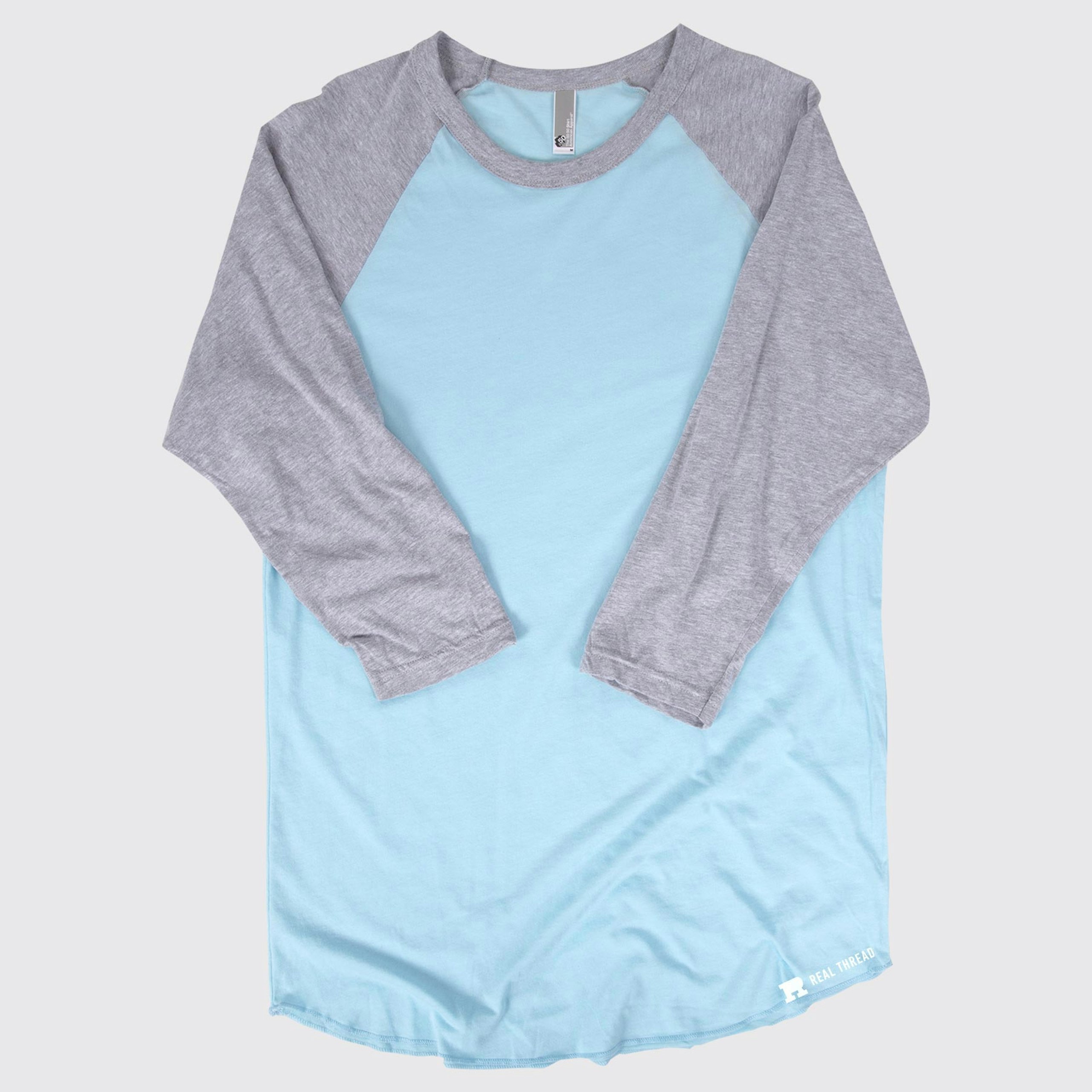 three quarter length sleeve shirt laying flat