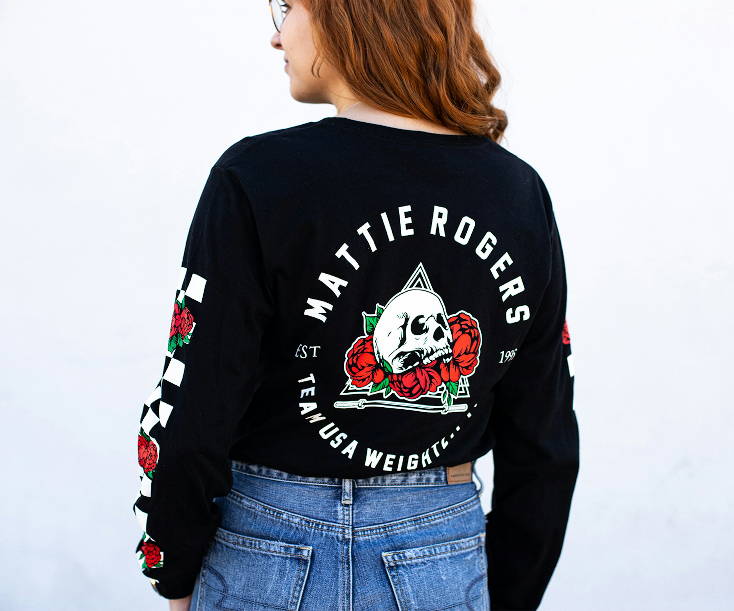 the back of a women wearing a long sleeve t-shirt