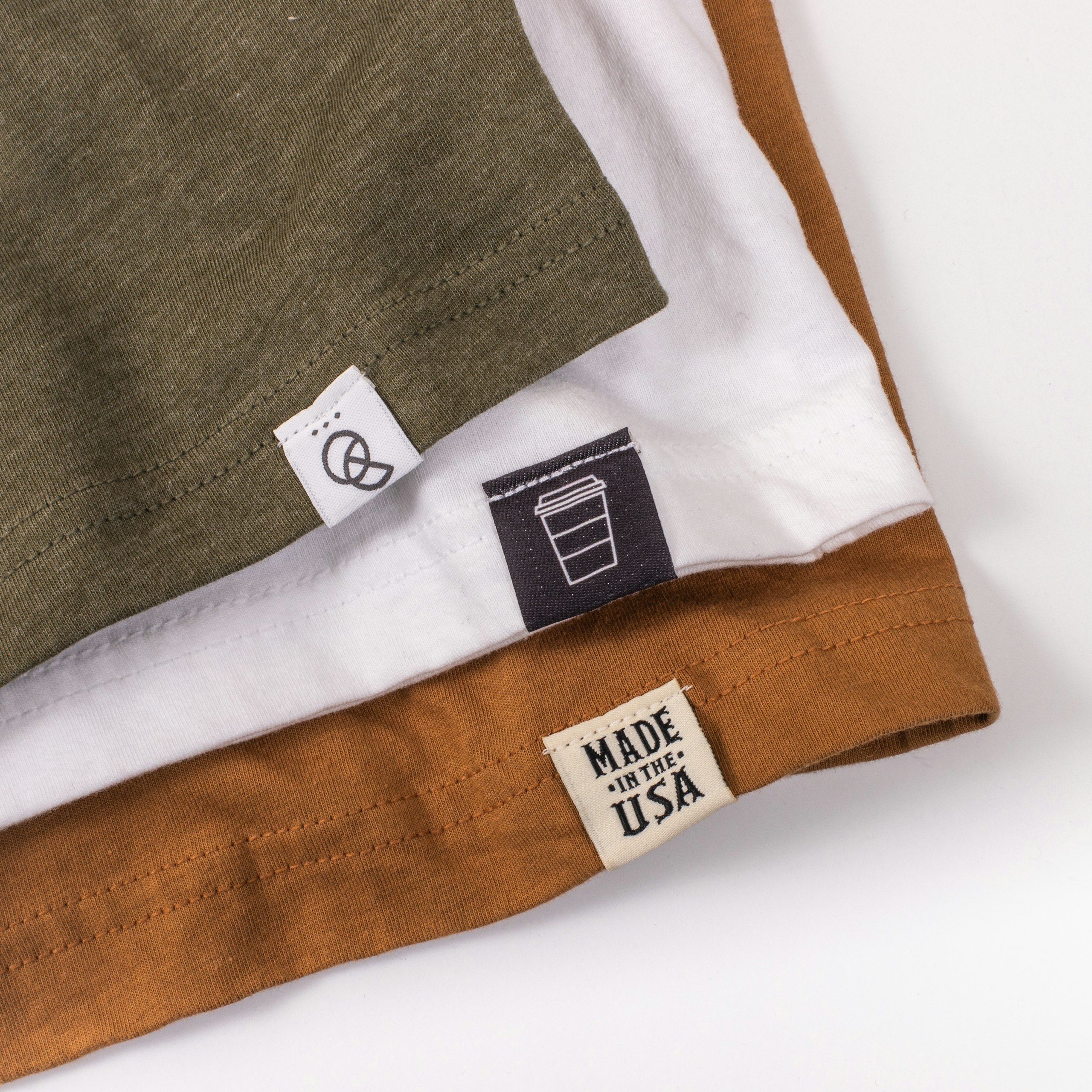 Three shirts with hem tags stacked up