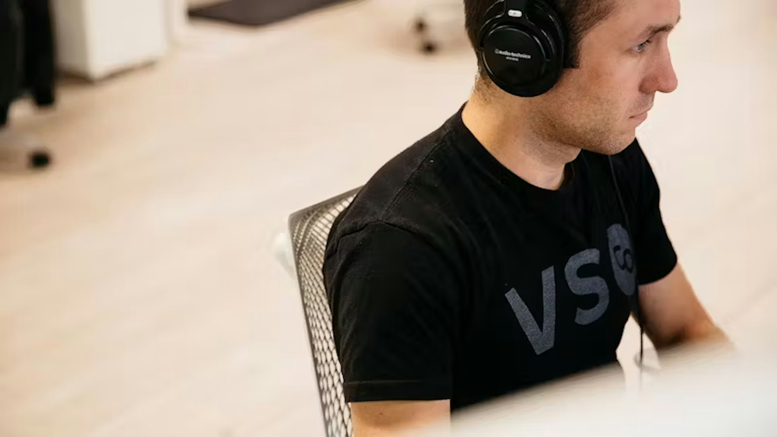 man sitting at a desk with headphones on