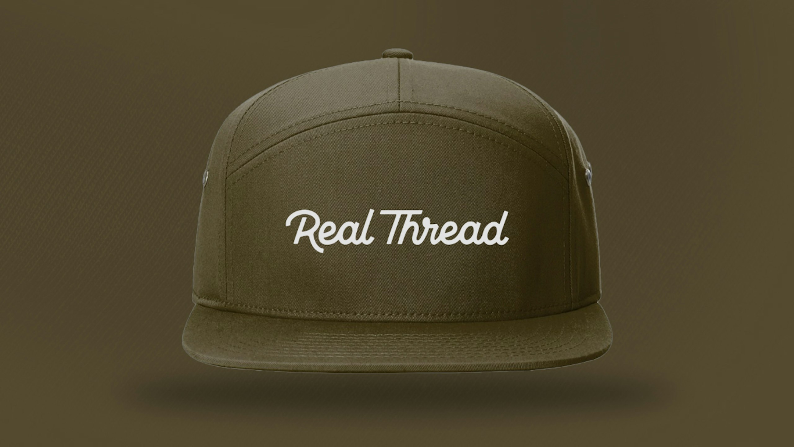A olive green hat with real thread on it