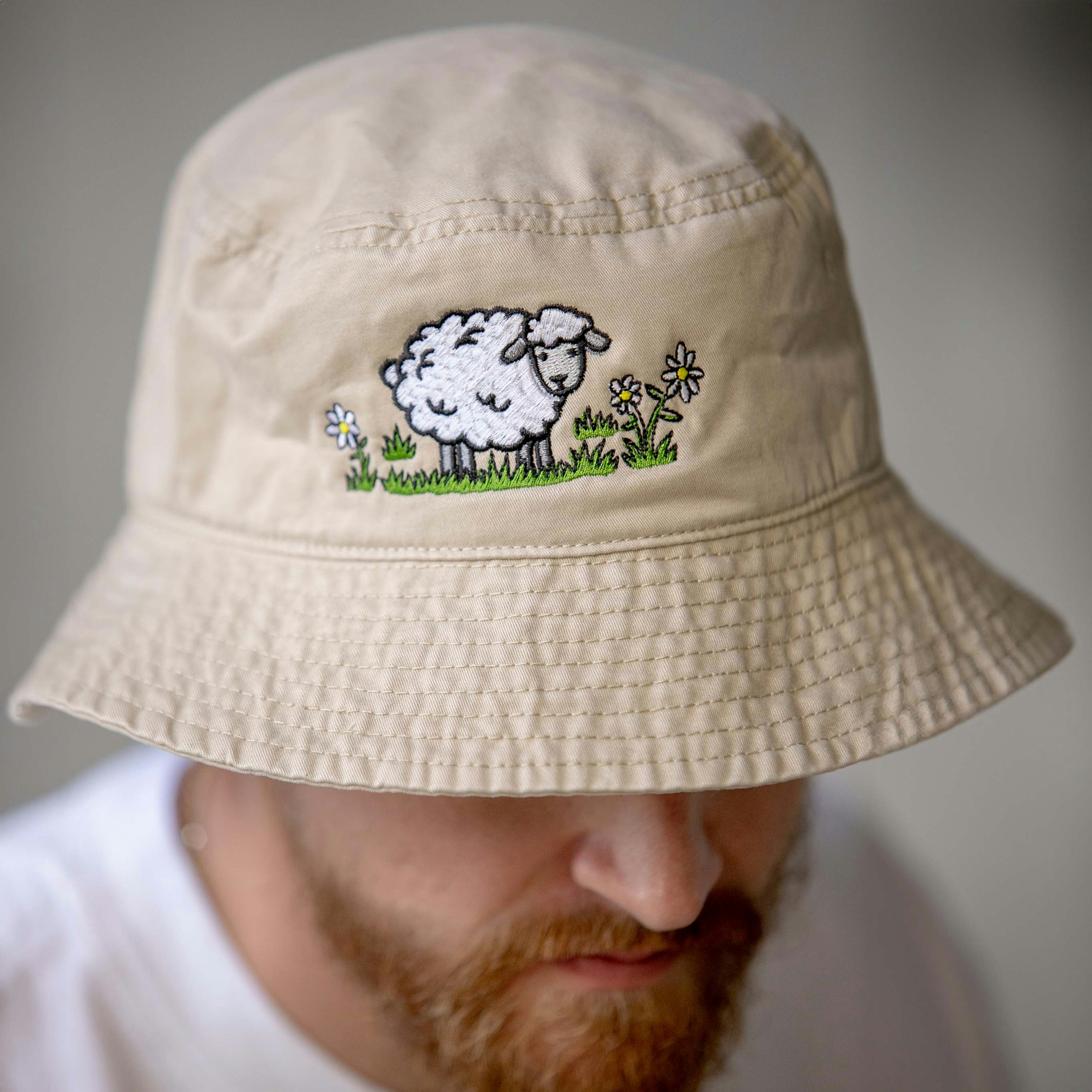 man wearing a light tan bucket hat