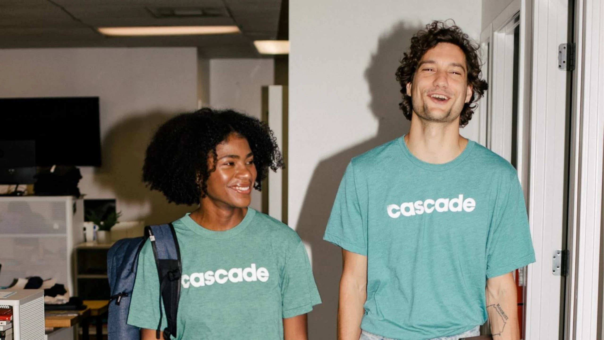 two people wearing green t-shirts