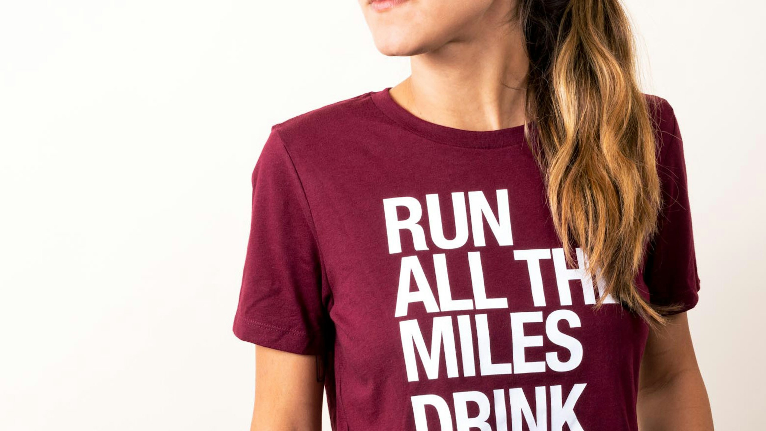 close up of a women wearing a maroon t-shirt