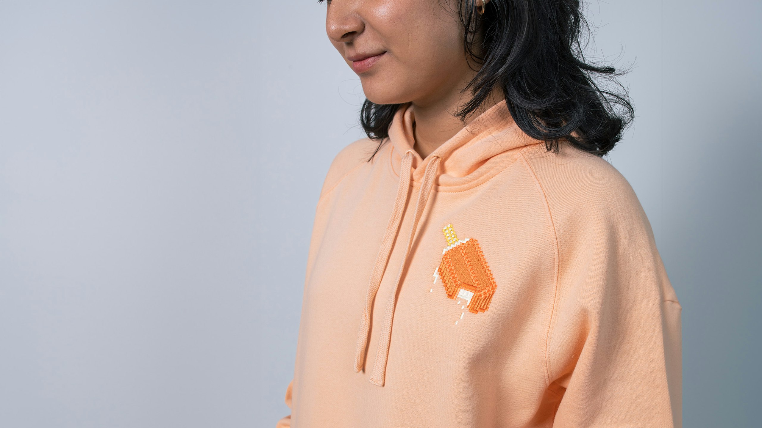 women wearing a peach color hoodie