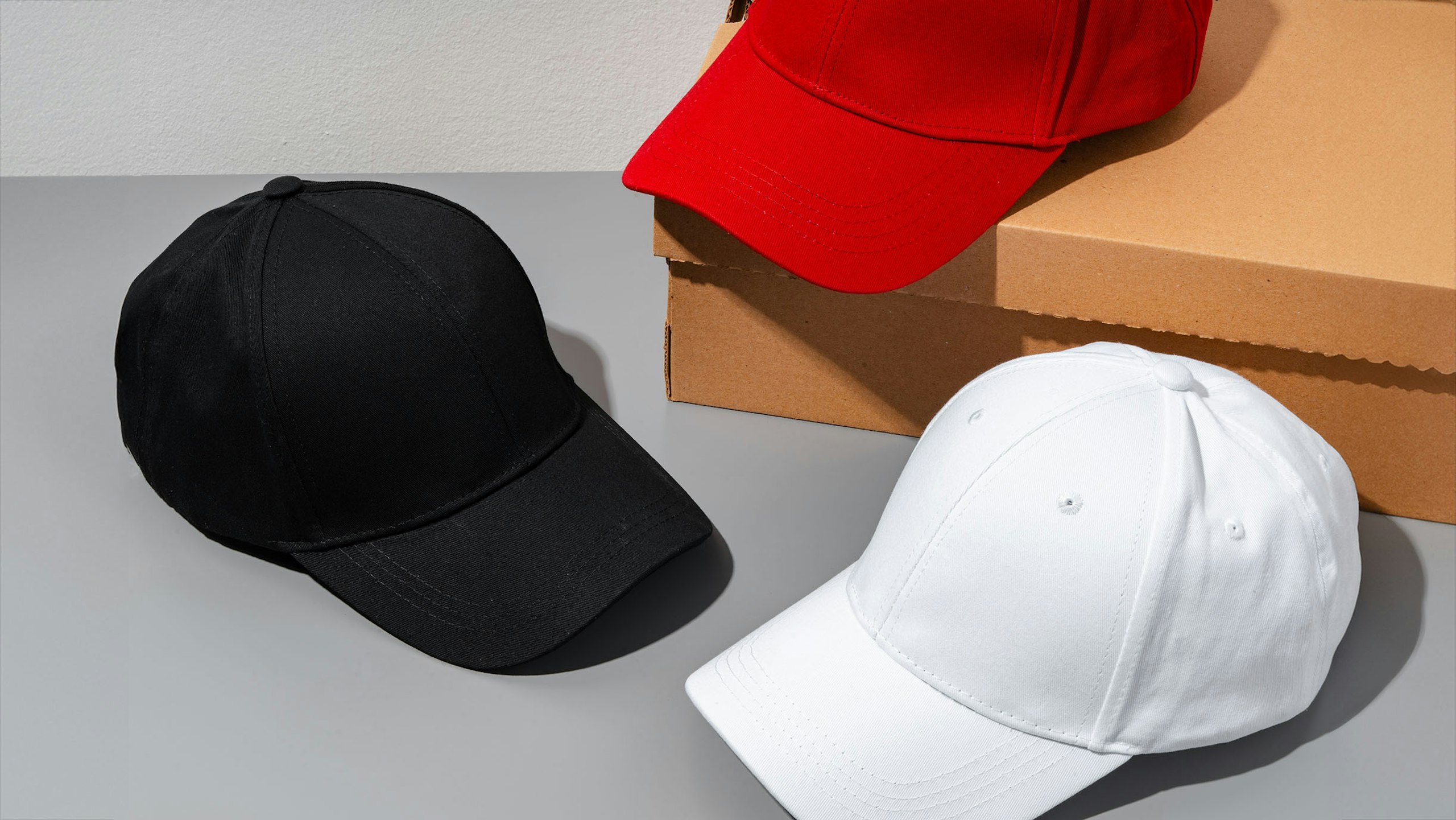 a black, white, and red hat sitting on a grey background