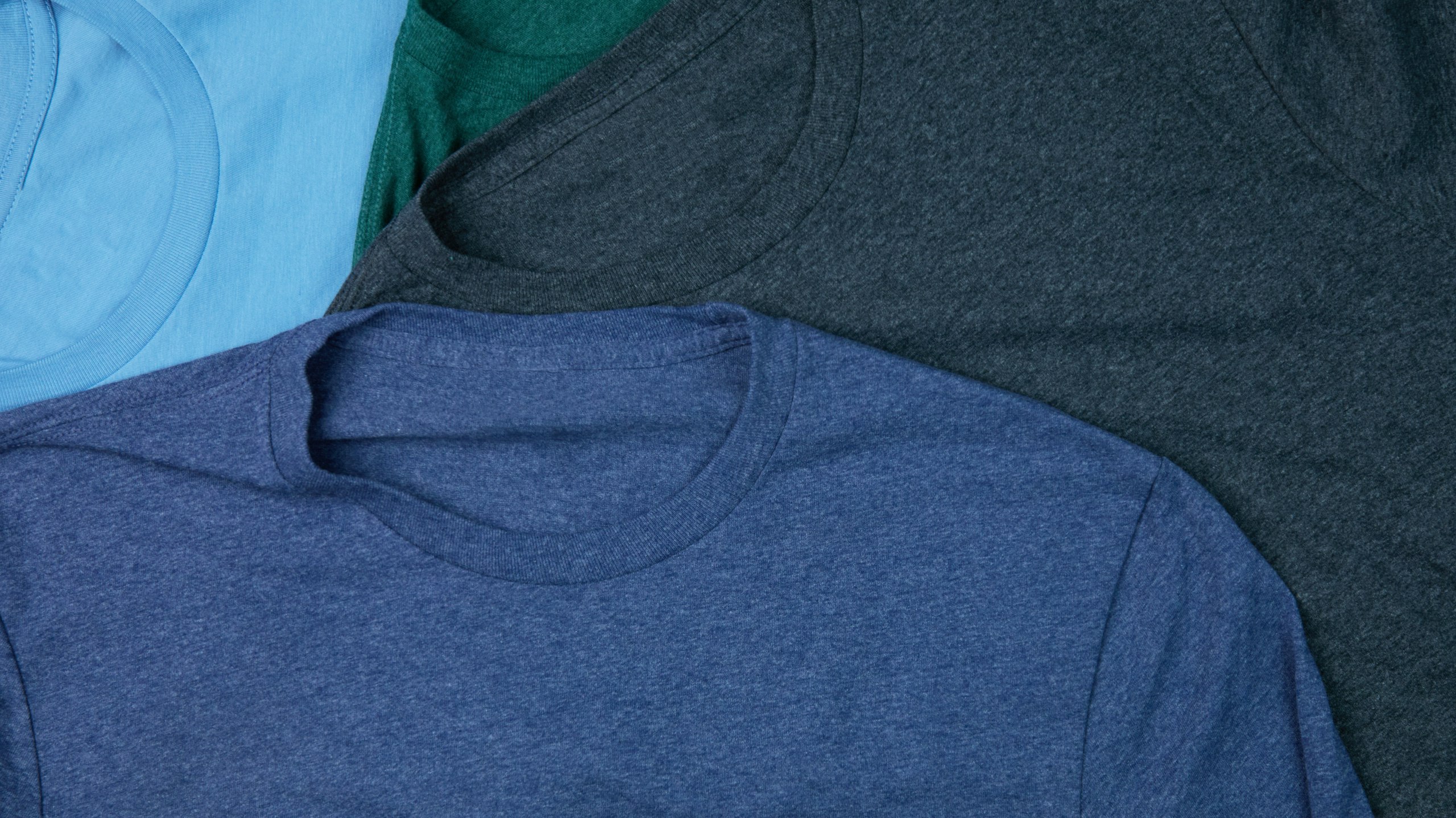 close-up of blue, light-blue, grey, and green t-shirt