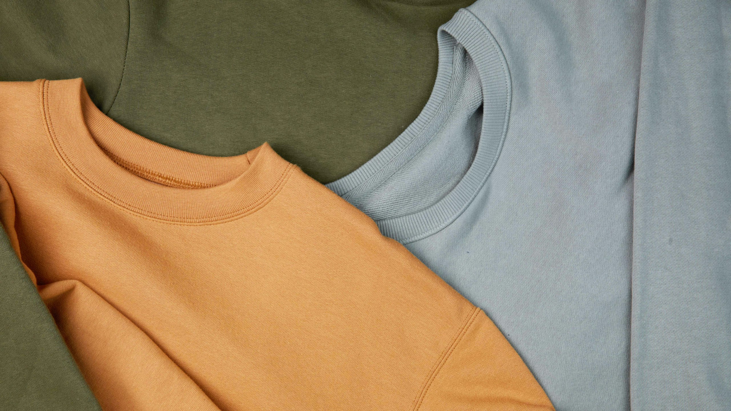 close-up of green, gold, and light blue sweatshirt