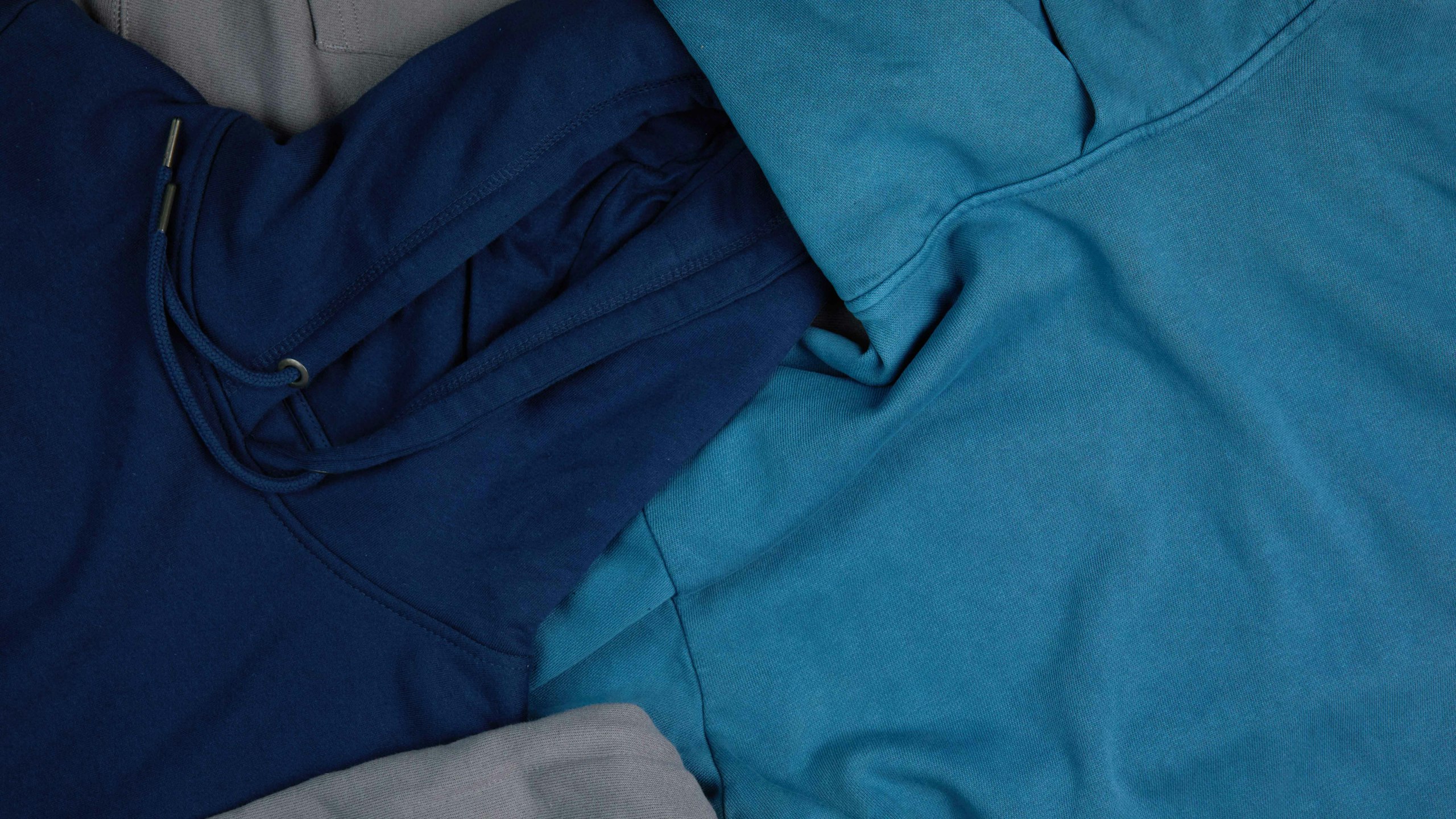 close-up of a navy, light blue, and grey hoodie