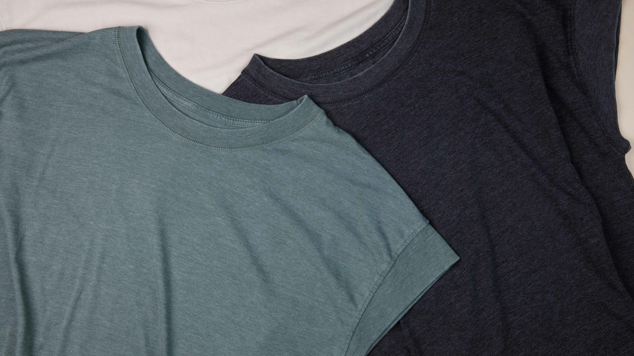 close-up of a green-blue, black, and tan women's sleeve-less shirt