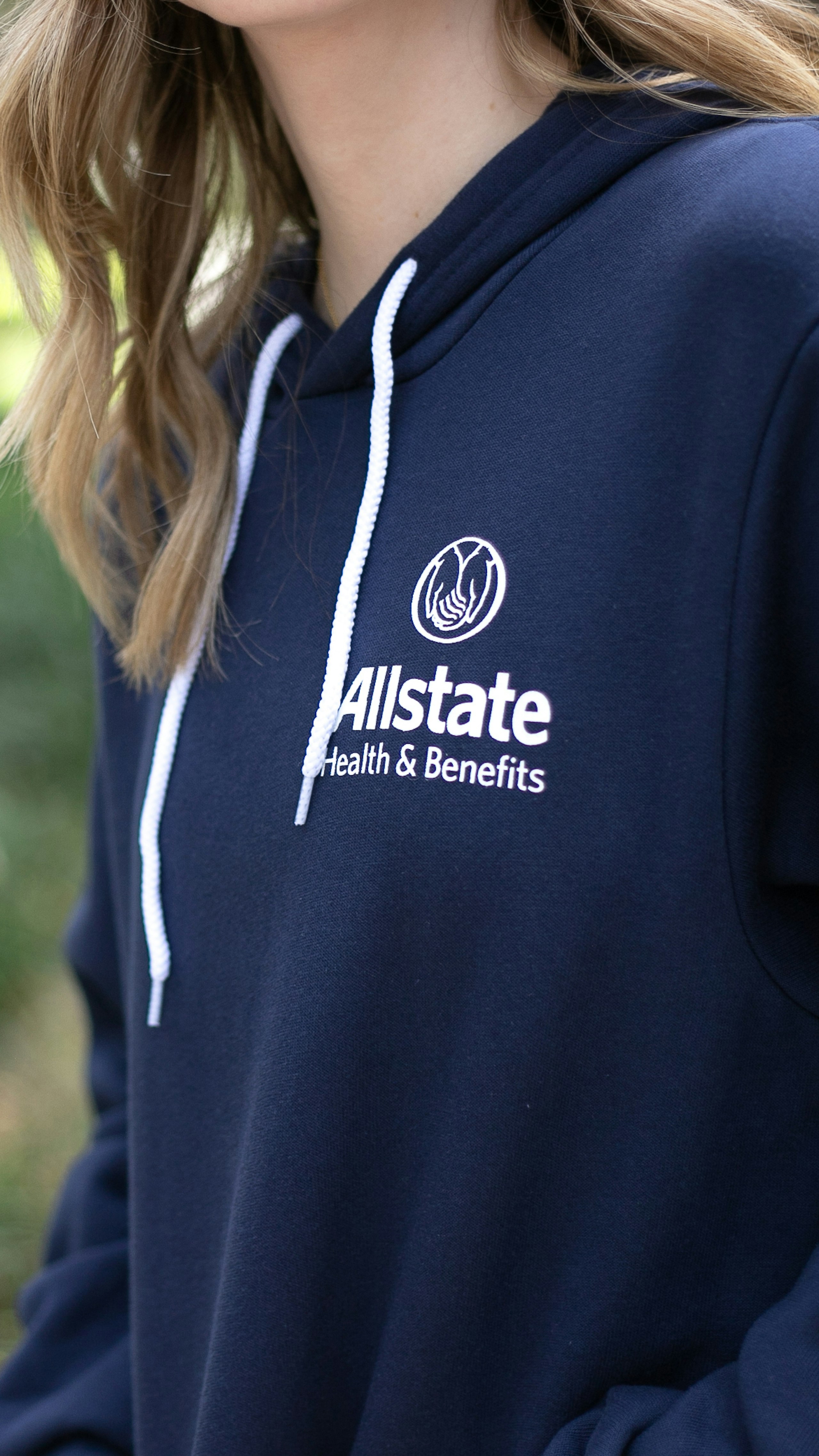 women wearing a blue hoodie with the Allstate logo