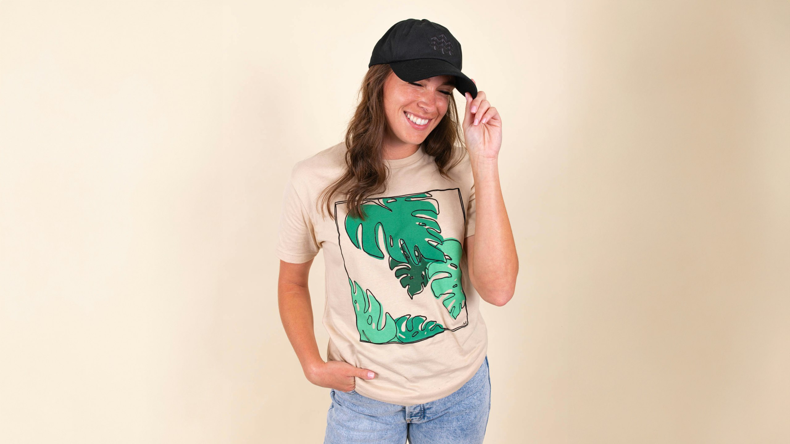Women wearing a tan shirt with leaves printed on it