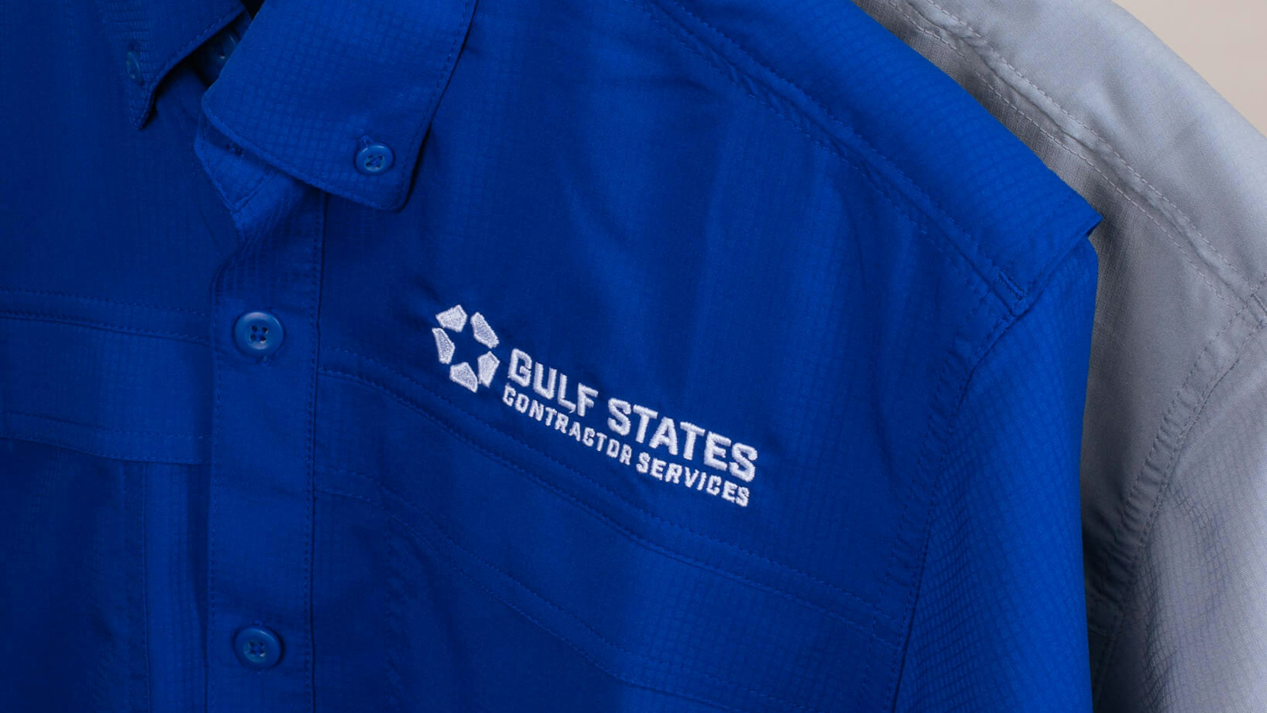 close-up of blue and grey button down shirts