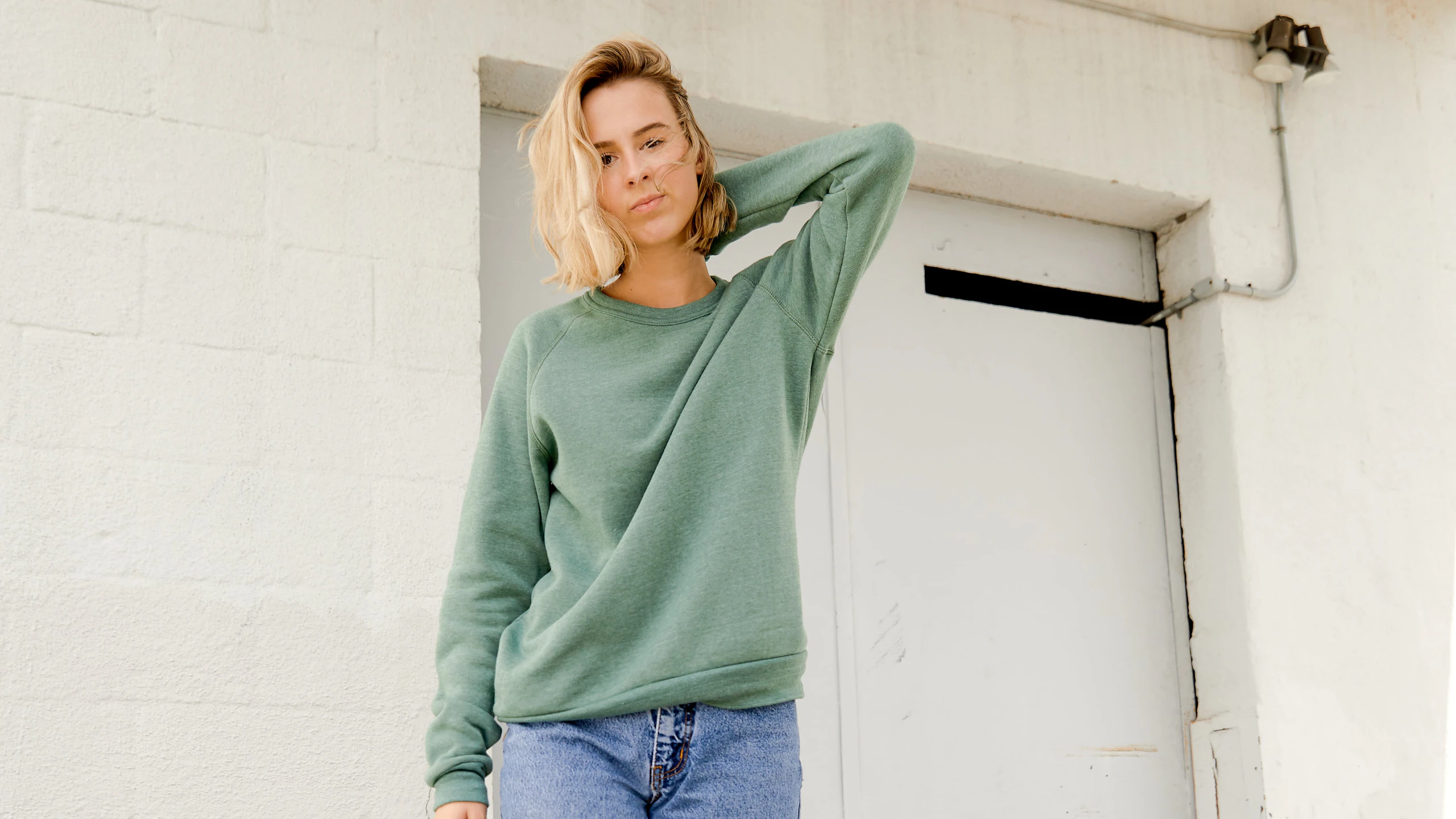 woman wearing a green sweatshirt