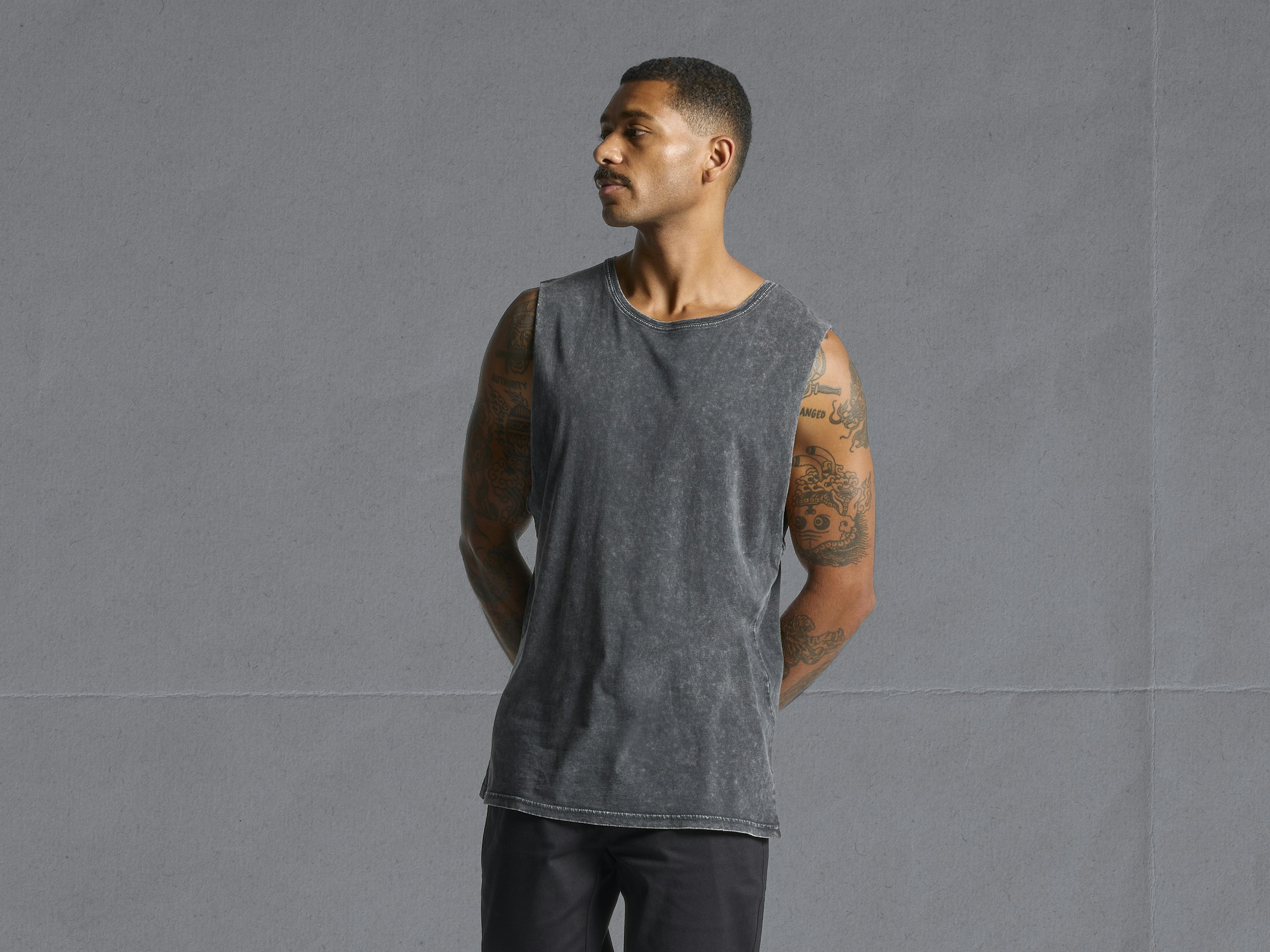 man wearing a black stone tank top