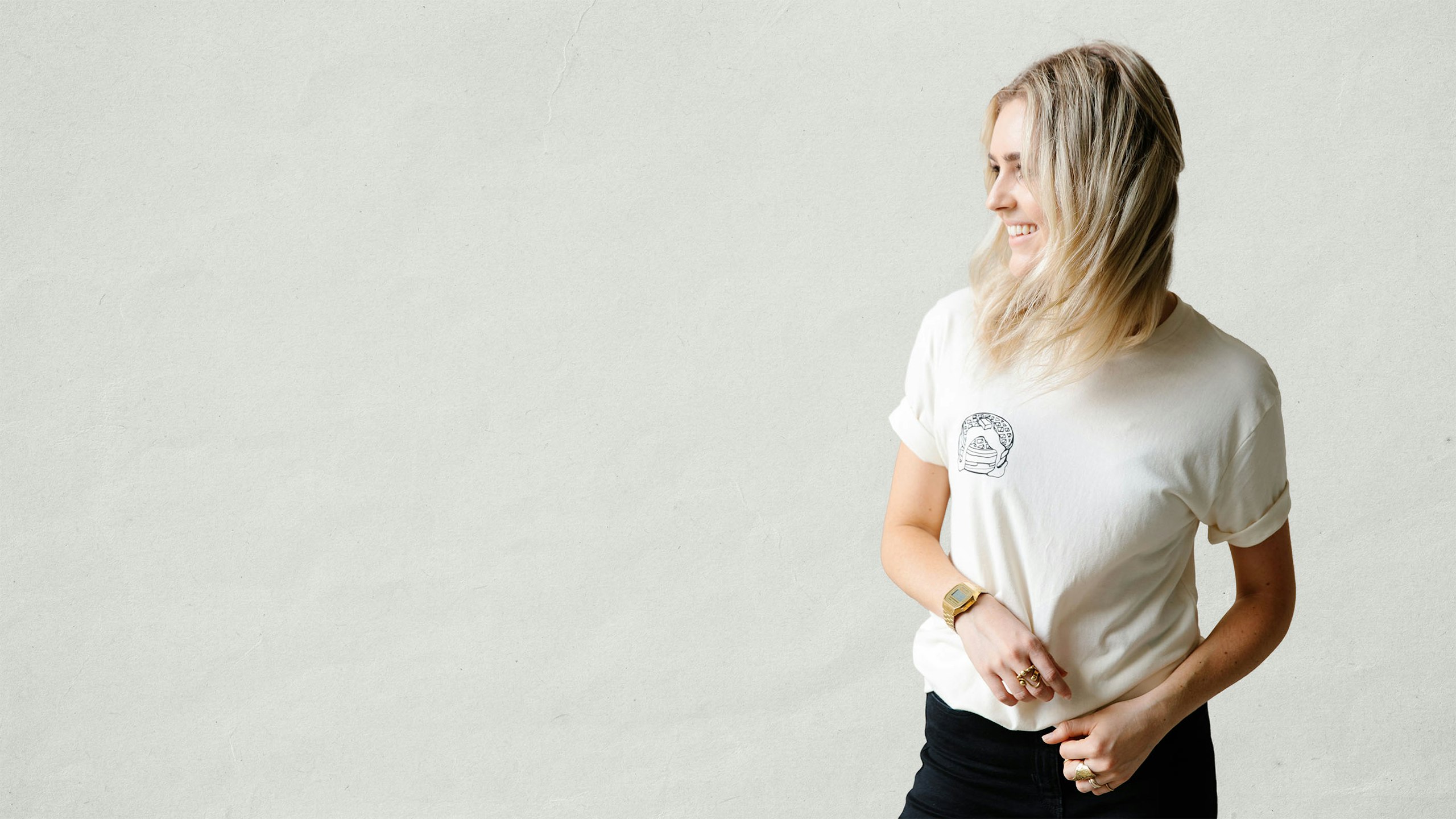women wearing a bone color t-shirt with pancakes printing on the left pocket