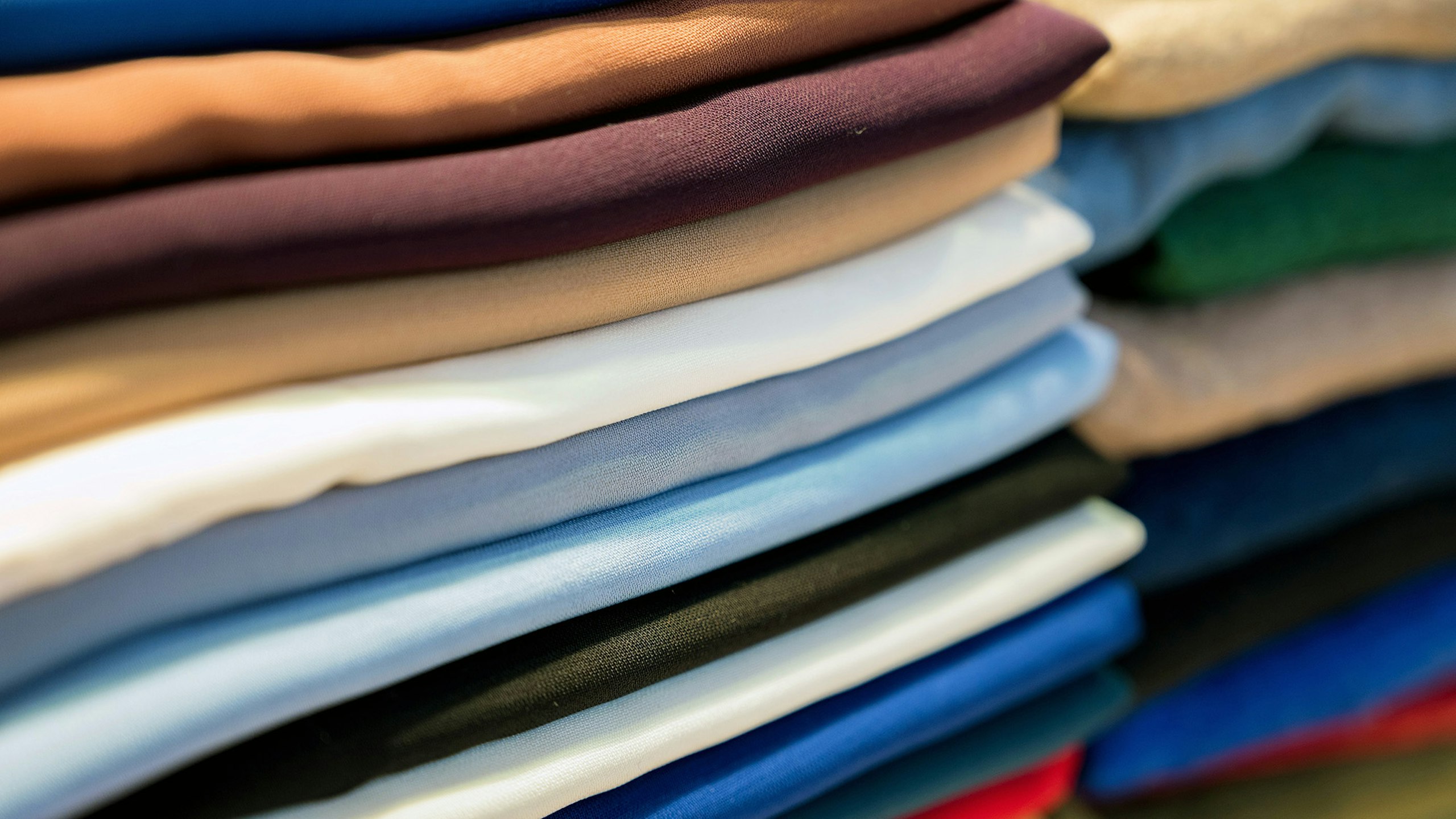 stack of t-shirts of different colors