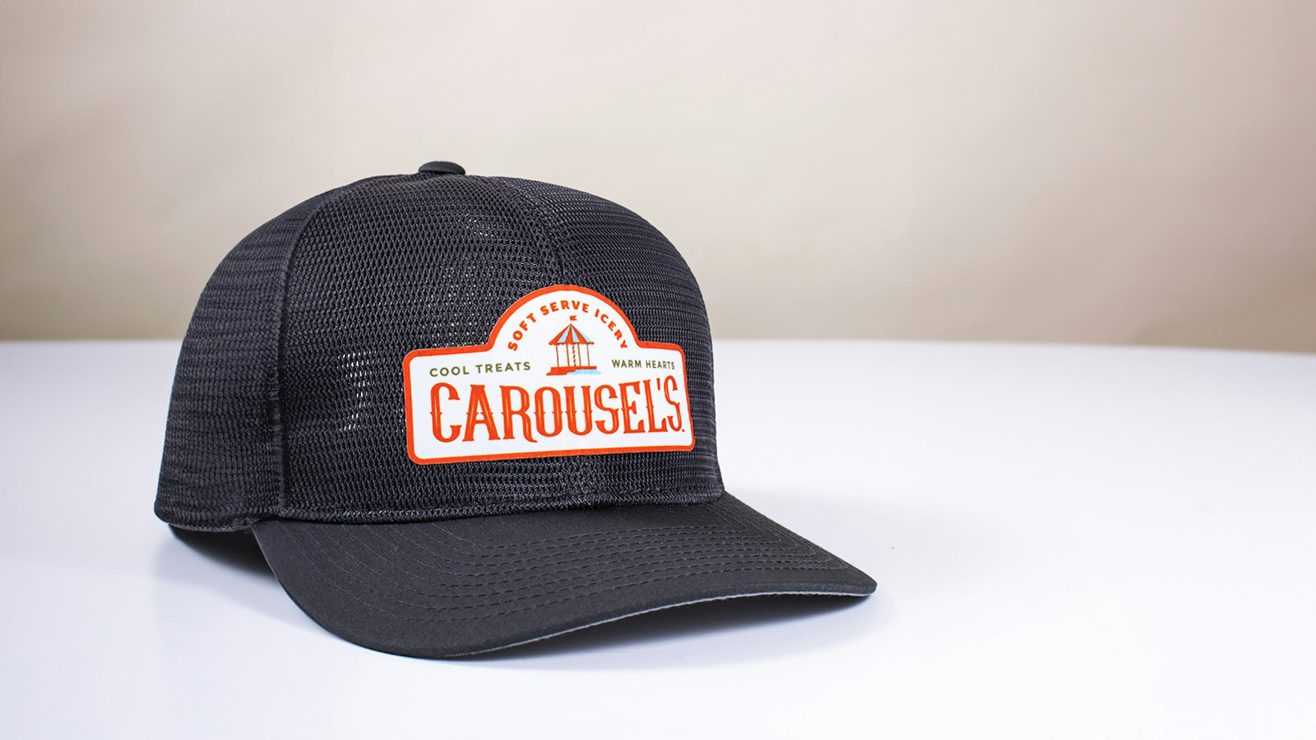 a black trucker hat sitting on a white table