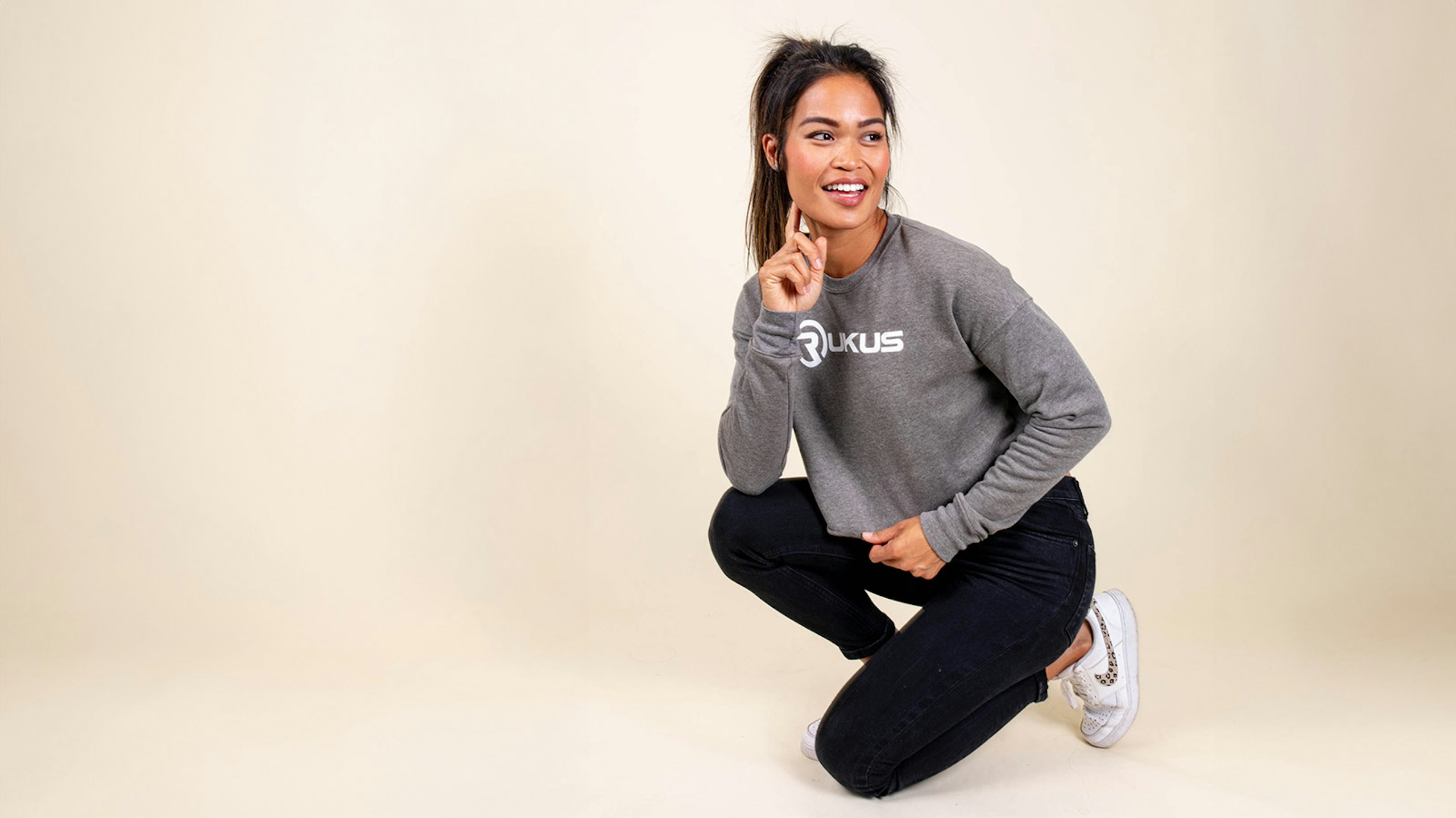 girl kneeling with a sweatshirt on it