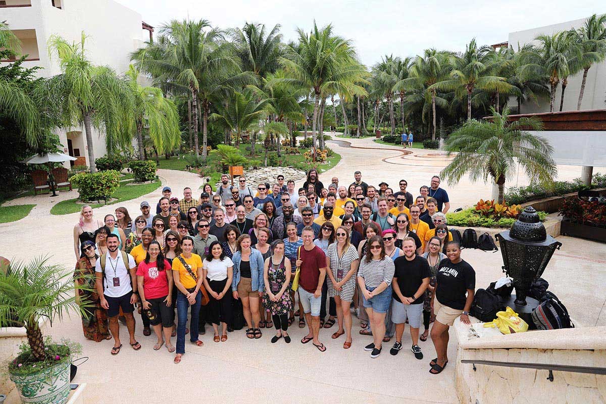 large group of people in a tropical place