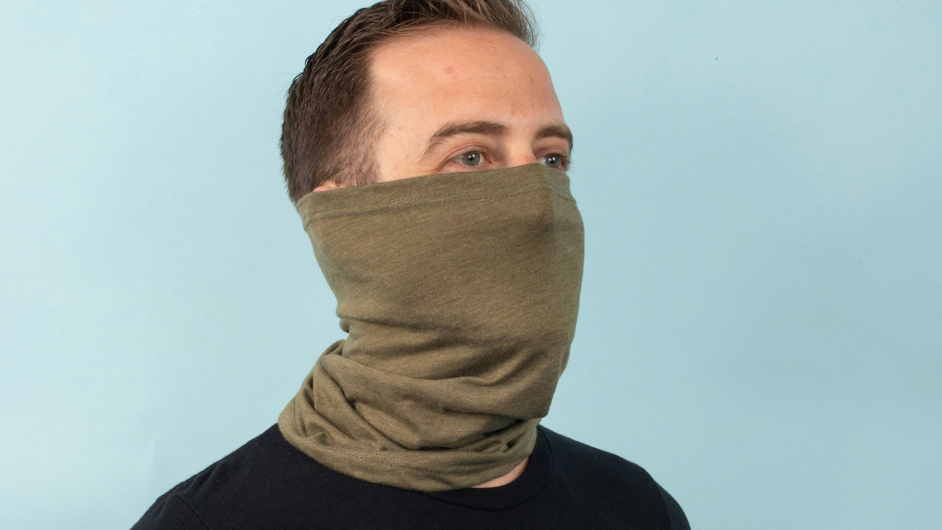 man wearing a military green neck gaiter 