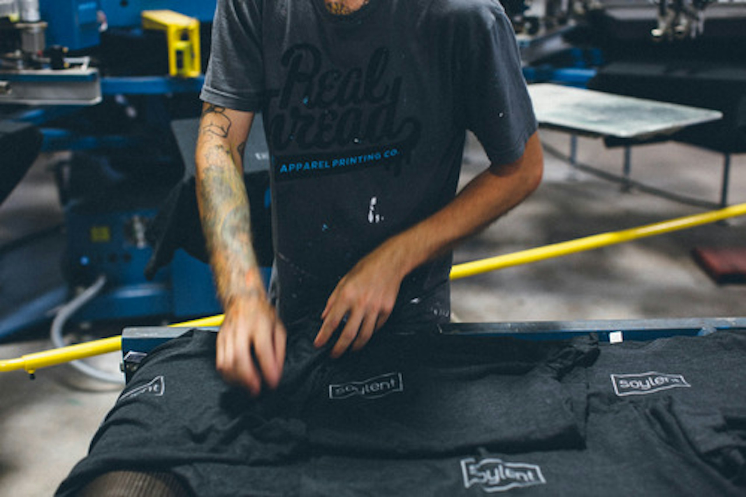 person folding t-shirts