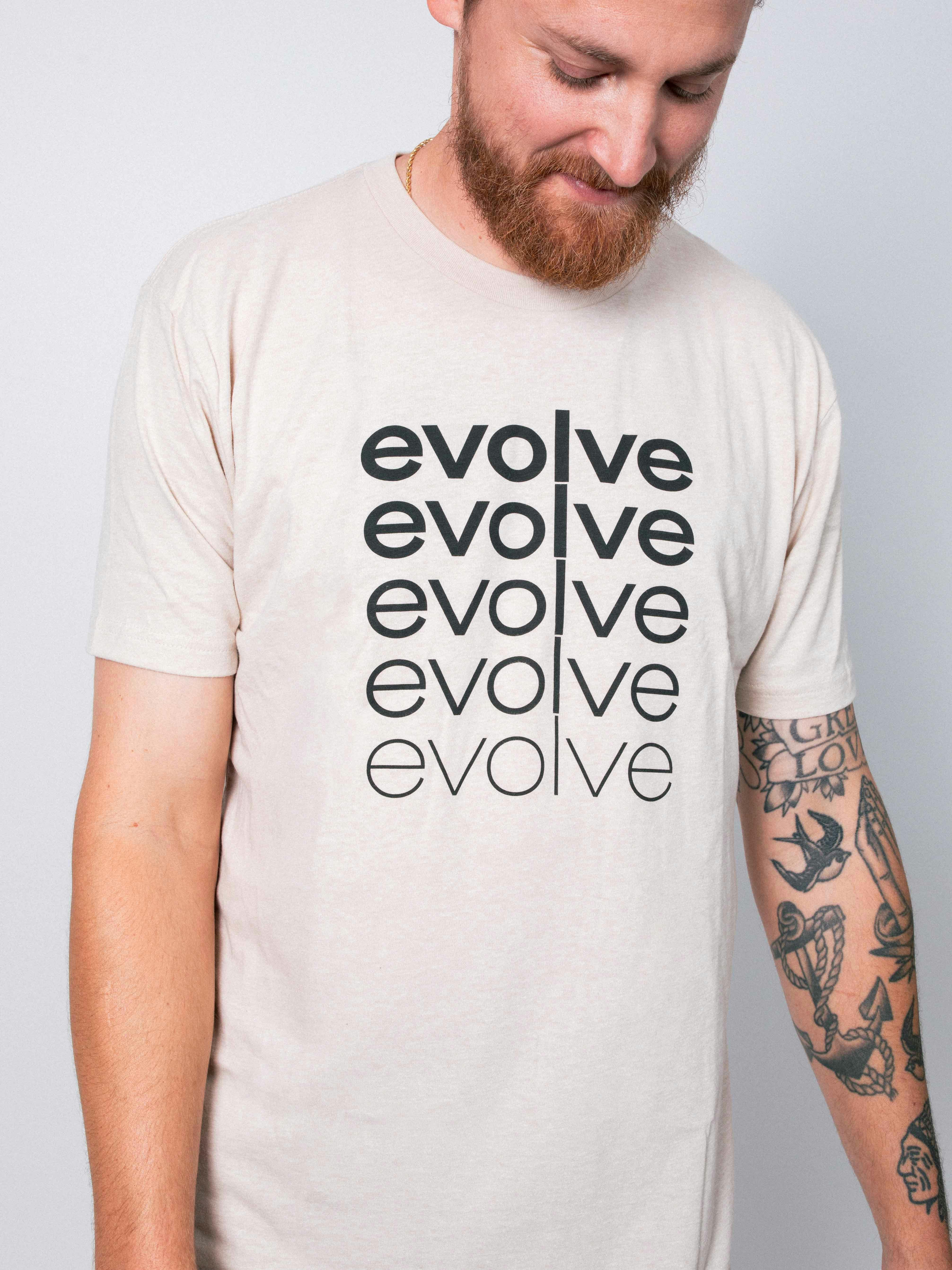 man wearing a white shirt with the word evolve printed in black