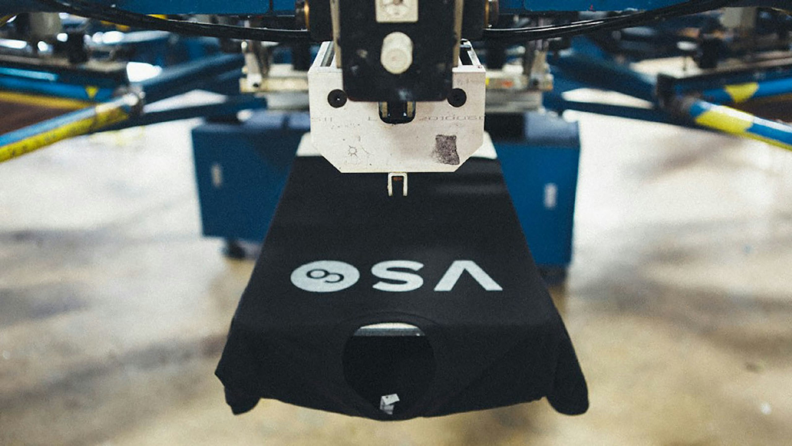black t-shirt on screen printing press
