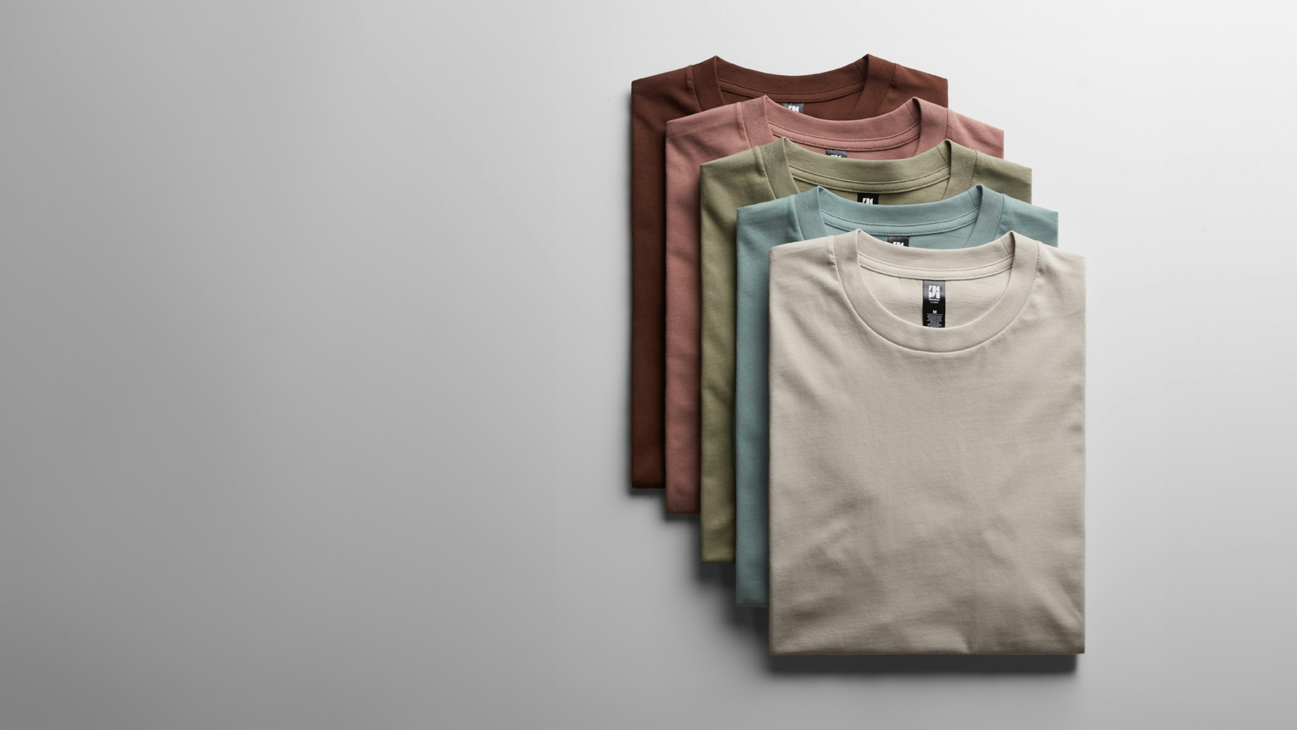 stack of folded as colour t-shirts