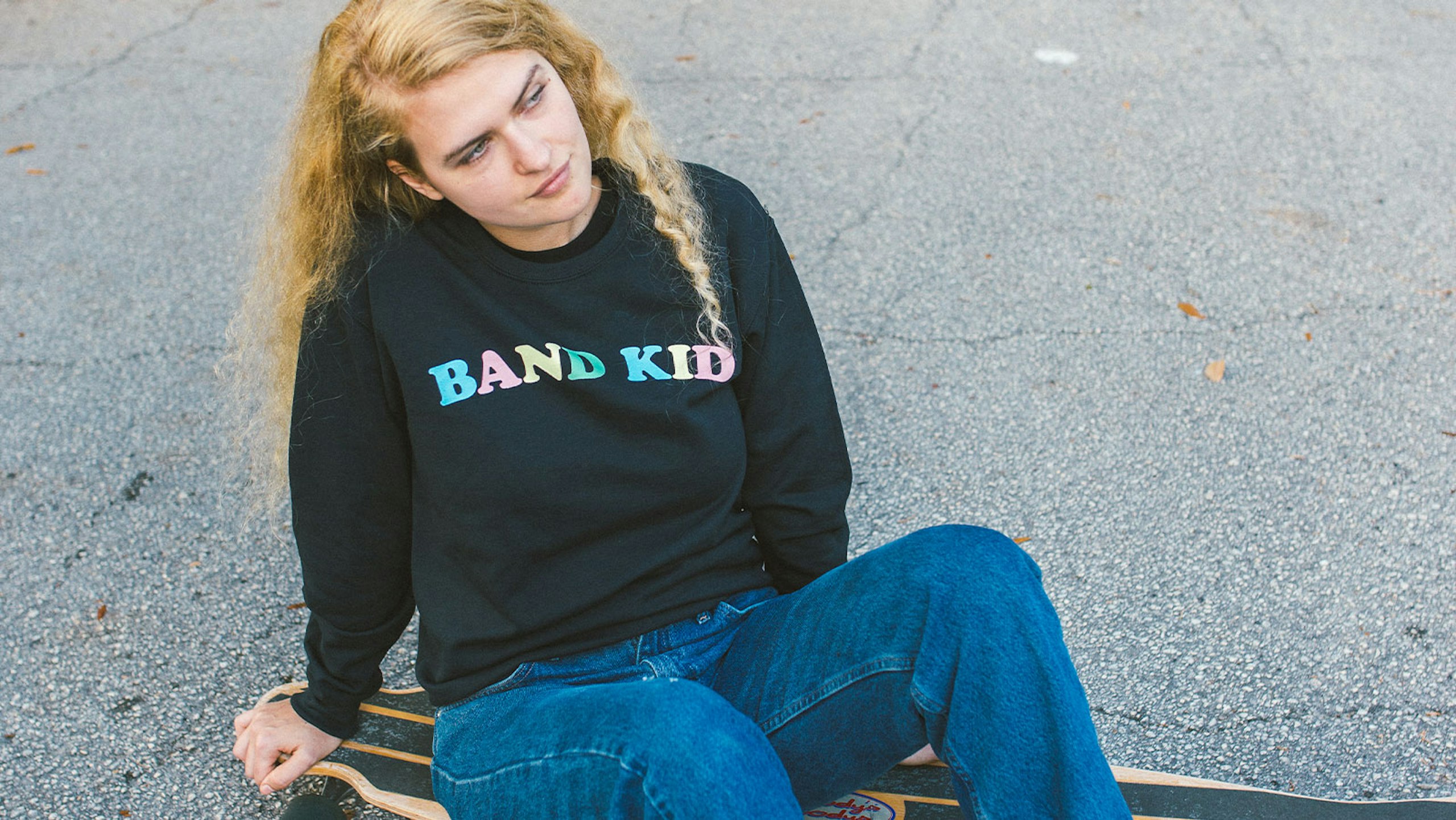 Women wearing a black sweatshirt that said, "Band Kid."