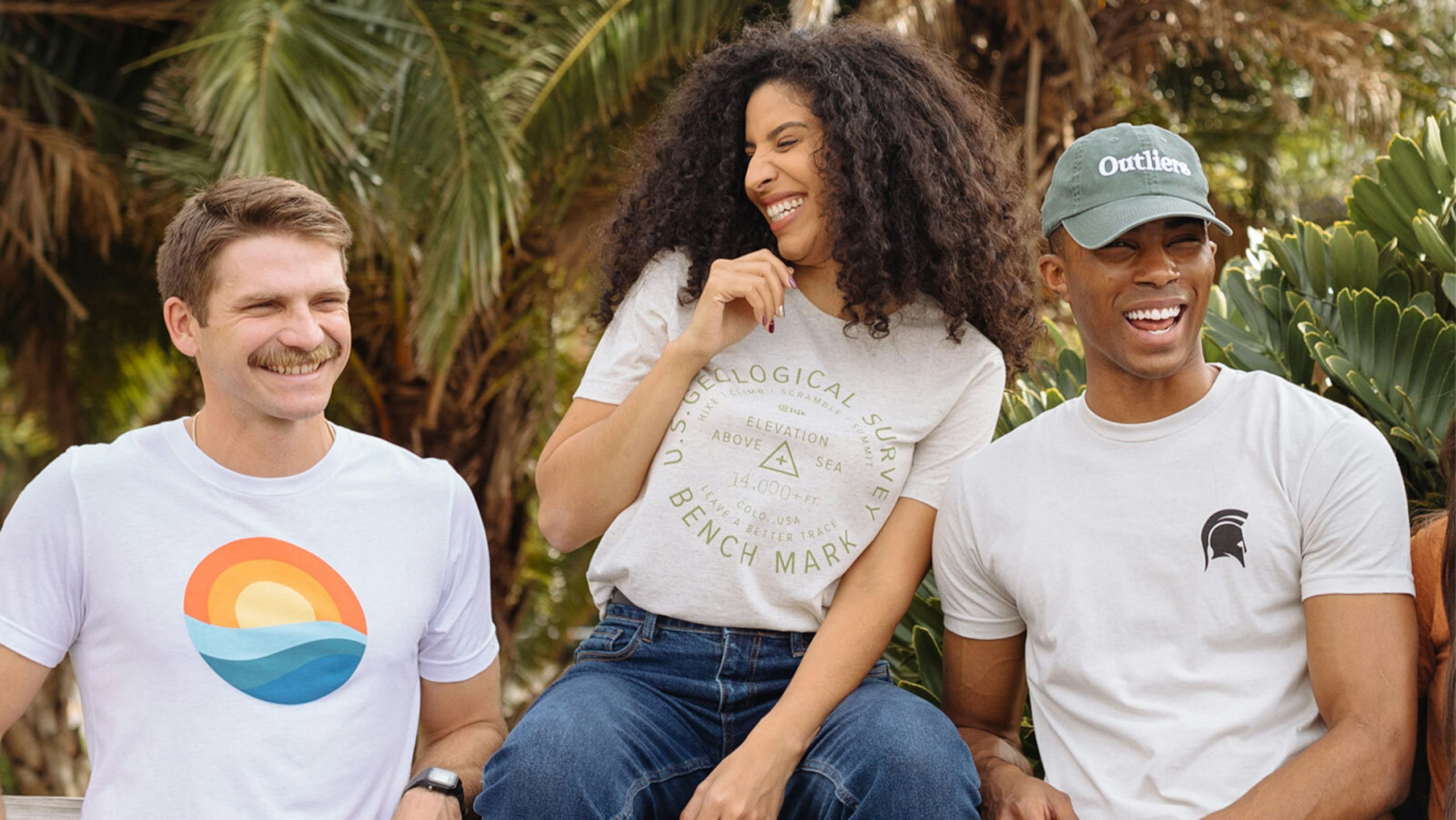 three people wearing white t-shirts with different designs on them