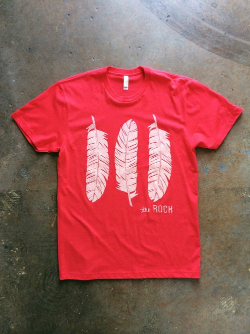 red shirt with a white feathers printed on it