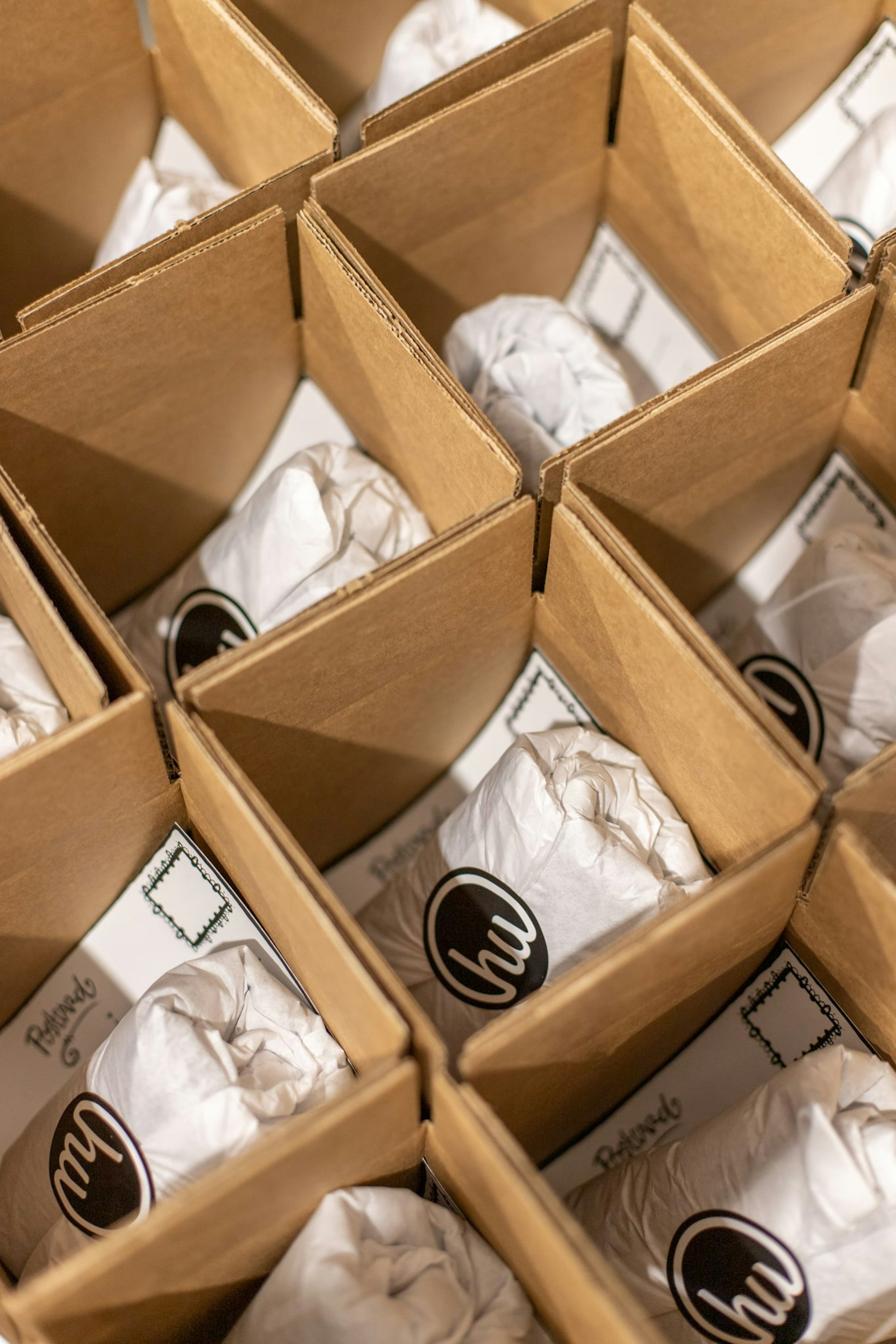 Rows of boxes stuffed with shirts in custom tissue wrap.