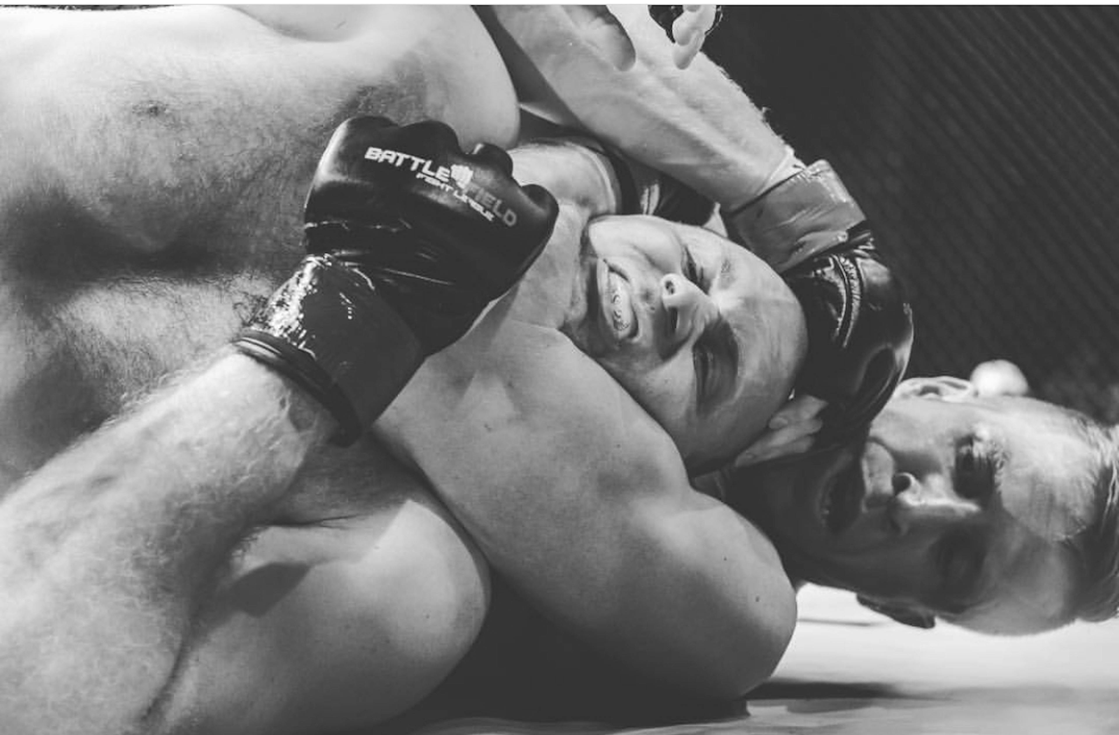 Jared with another fighter in a rear-naked choke during a professional MMA fight