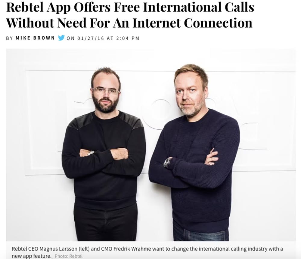 Screenshot of an International Business Times article titled "Rebtel App Offers Free International Calls Without Need For An Internet Connection". The lead image shows 2 white men in dark clothes standing in front of a white wall.