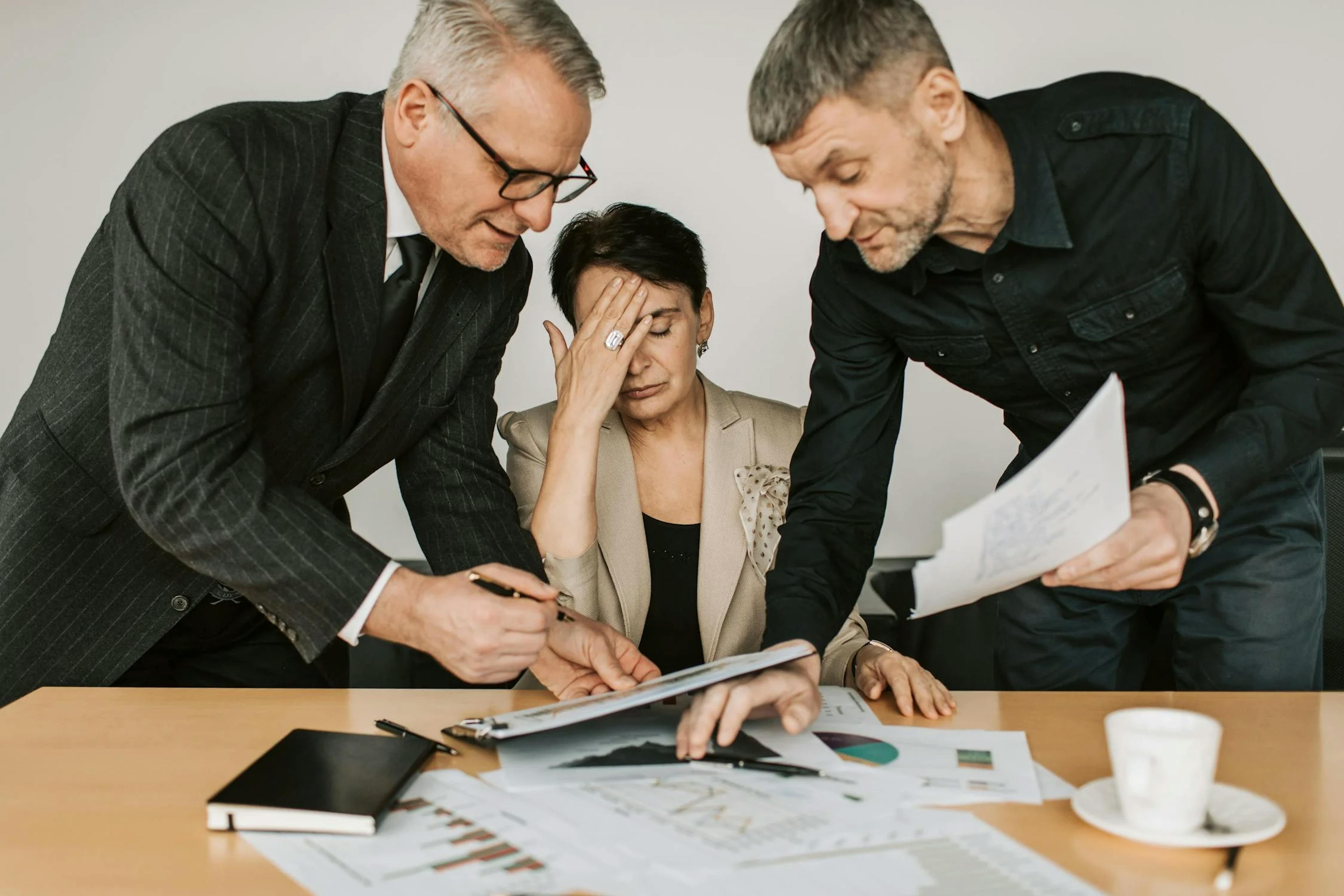 2 men discussing and confused woman at the center